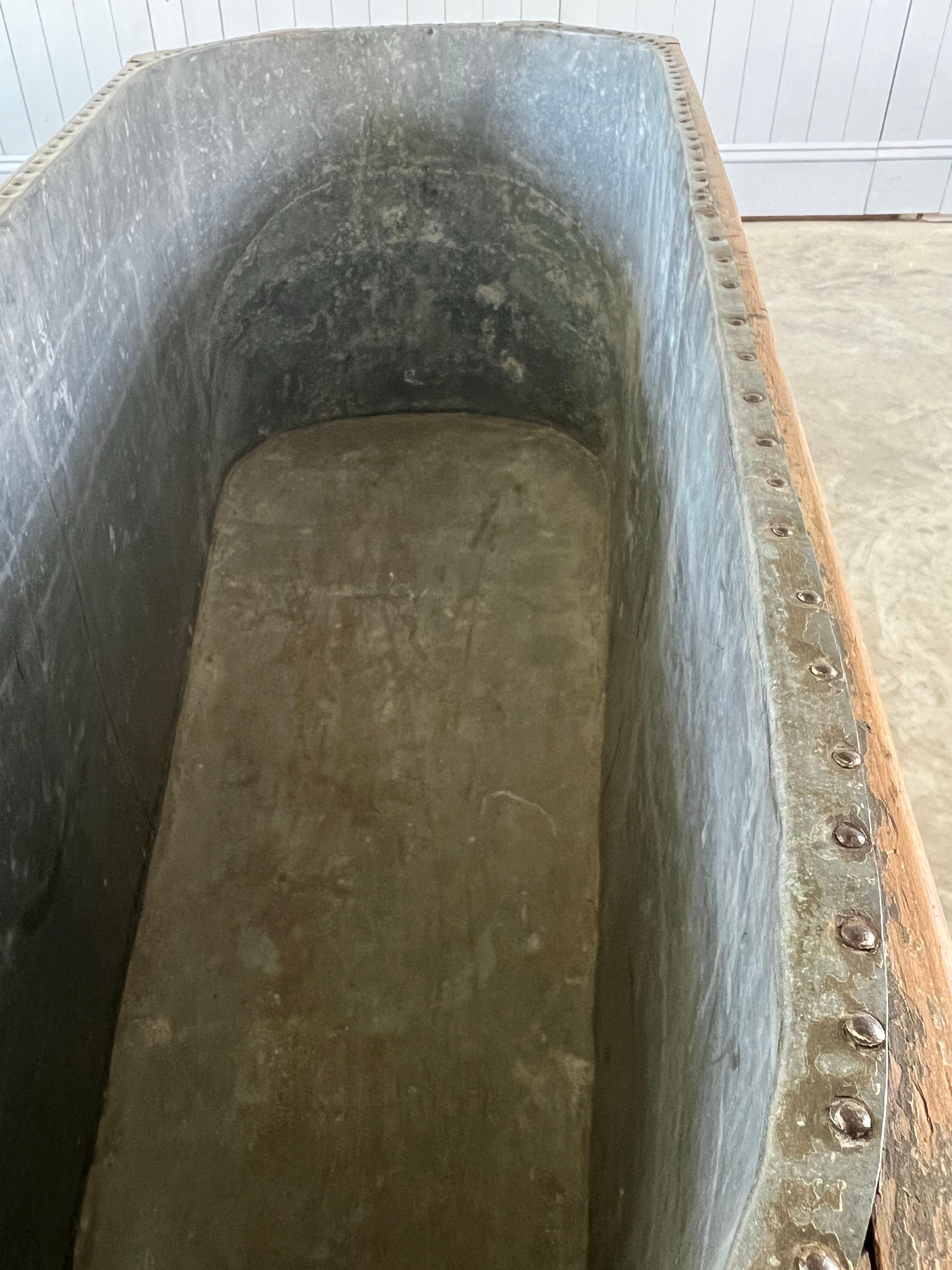 This is a very unusual zinc bath with a beautifully made oak frame.  Sourced from the Ardennes in Northern France.

Fantastic patina to both the frame and the zinc.  We have filled this up with water and it is watertight.

Great as a planter or even