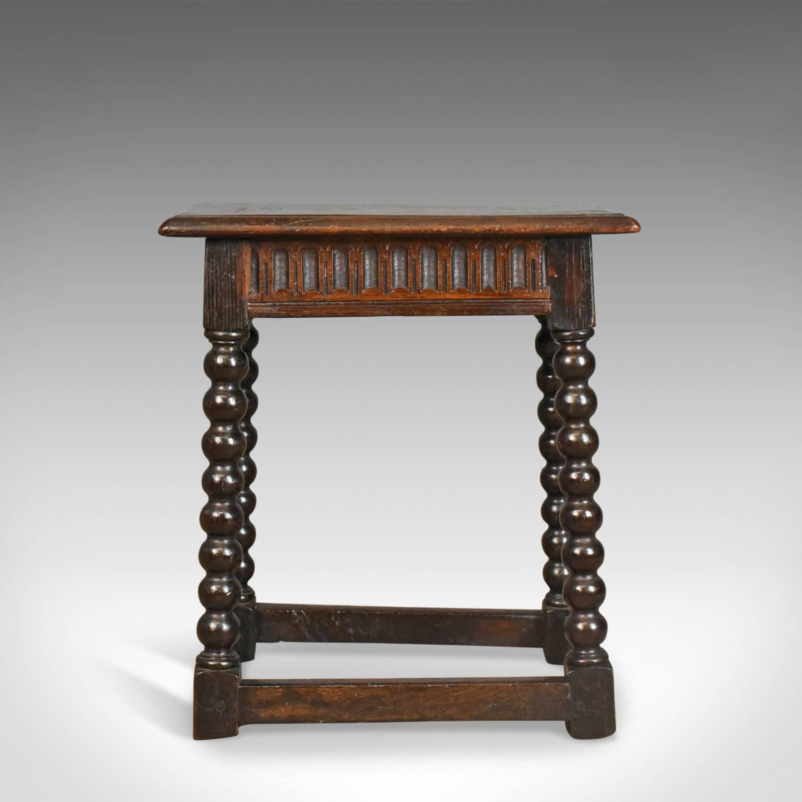 This is an antique joint stool. An English, late Georgian, oak seat dating to circa 1800.

Good consistent colour to the dark English oak 
Of quality craftsmanship displaying grain interest to the top
Solidly constructed with desirable aged