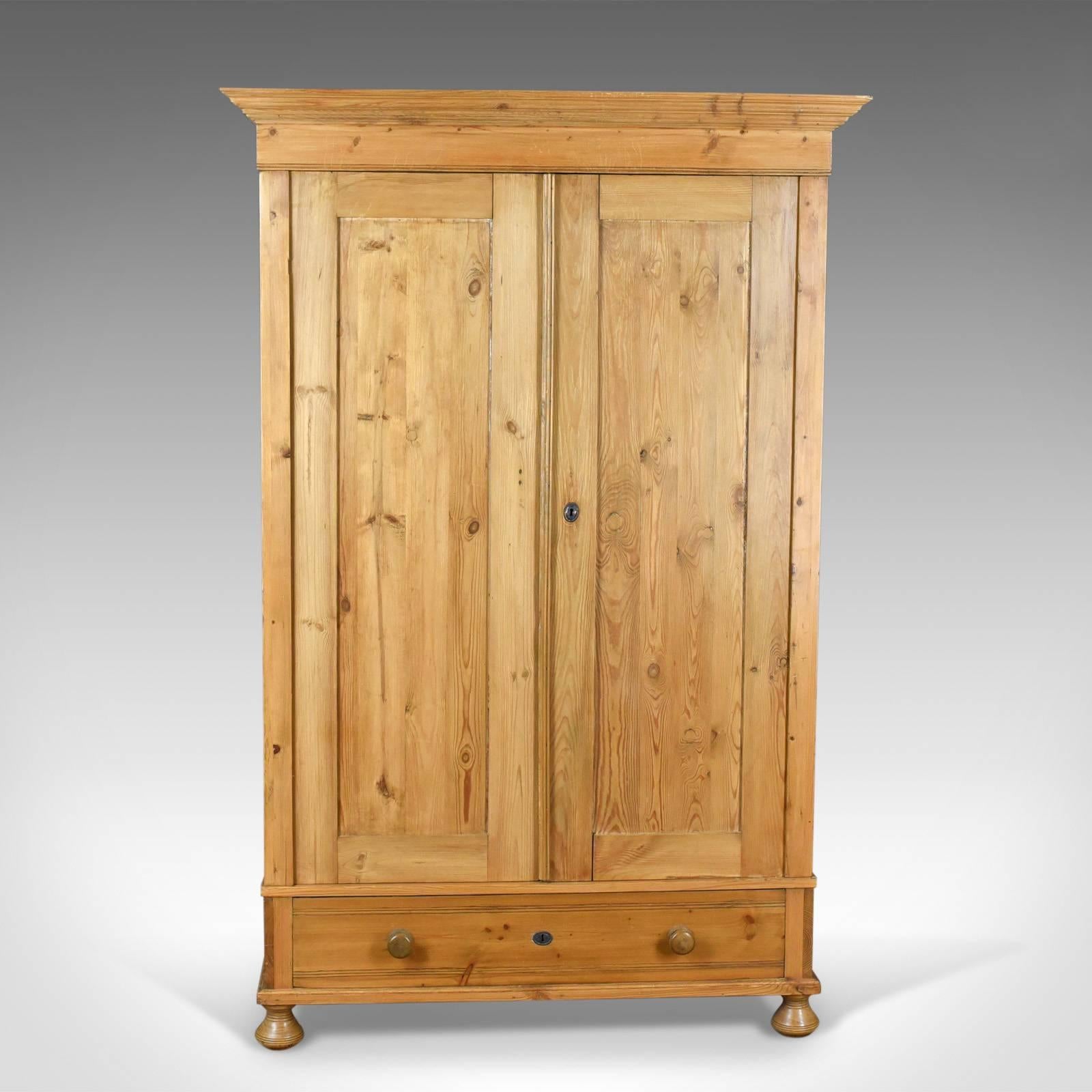 This is an antique wardrobe, a French provincial pine compactum cupboard dating to the early 20th century, circa 1900.

Attractive French provincial cabinet
Pine with grain interest in a wax polished finish
Arranged two doors over single full
