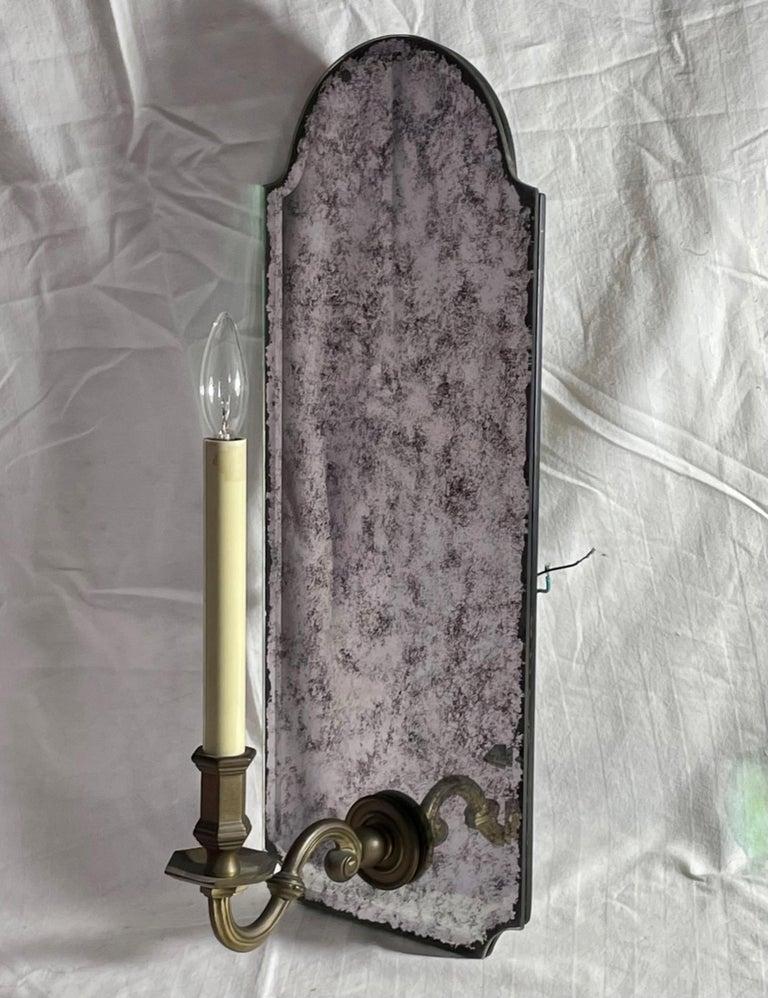 Antiqued Mirror Wall Sconce with Patinated Electrified Brass Arm. - 3  In Good Condition For Sale In Vero Beach, FL