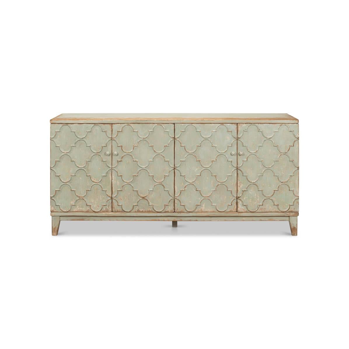 This exquisite piece boasts a tranquil sage green finish, gently distressed to reveal undertones of natural wood for a perfectly aged look. The front fascia is adorned with arabesque mosaic patterns, creating a captivating visual. Behind the four