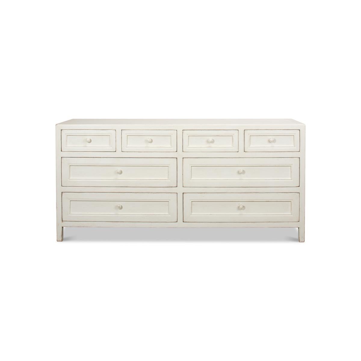 An antiqued white Rustic painted dresser with eight drawers. Reclaimed pine painted and distressed with four short and four long drawers. Influenced by antique Chinese furniture, this dresser is ideal in modern or traditional