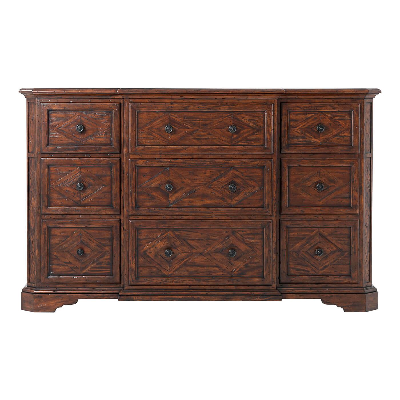 An antiqued wood breakfront dresser with lozenge parquetry top and drawer fronts, the molded edge top above nine deep drawers with brass handles, on bracket feet.

Dimensions: 68