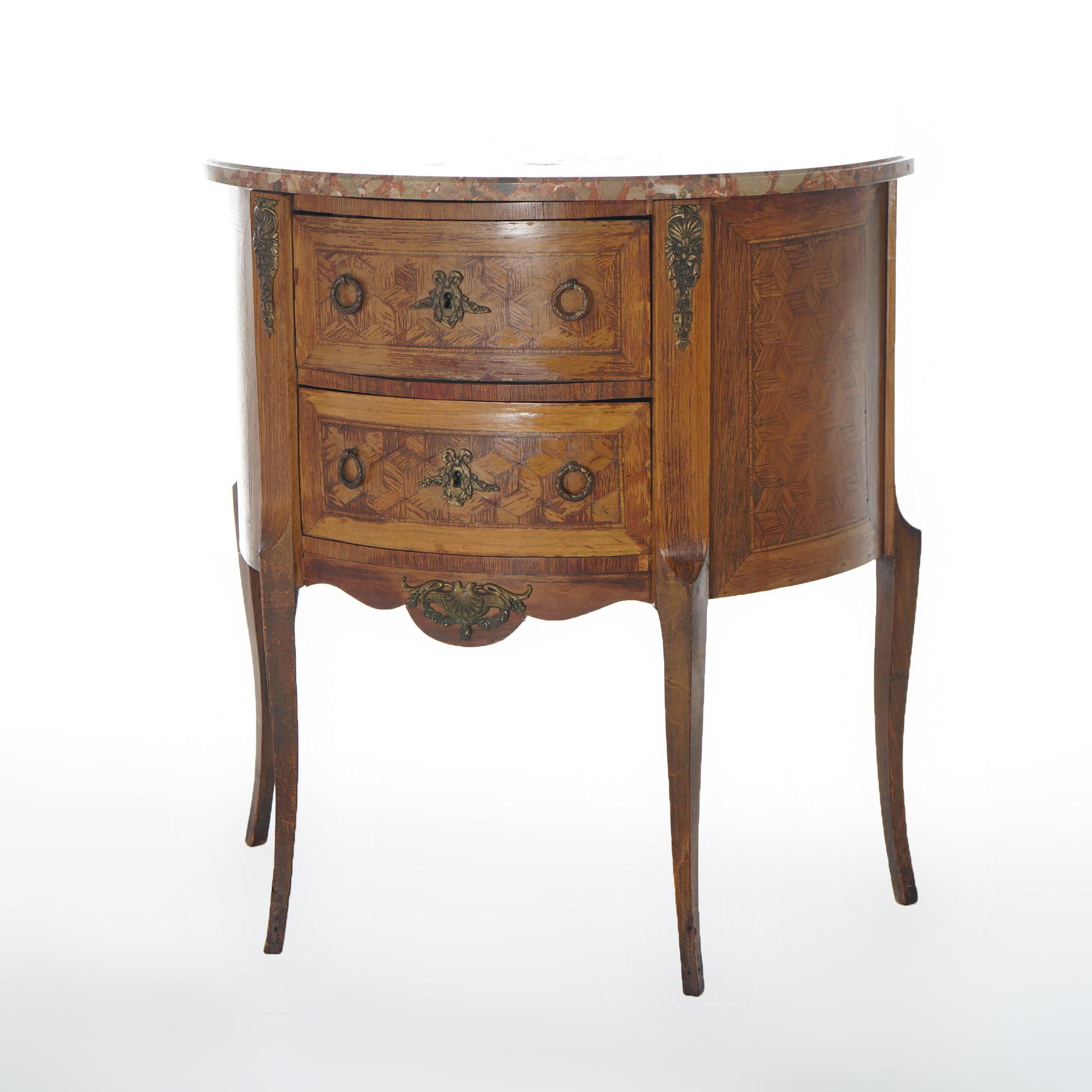An antique French side stand offers specimen marble top over kingwood and satinwood case in demilune form with shaped skirt and having two drawers, cast bronze mounts and raised on cabriole legs, c1920

Measures - 36