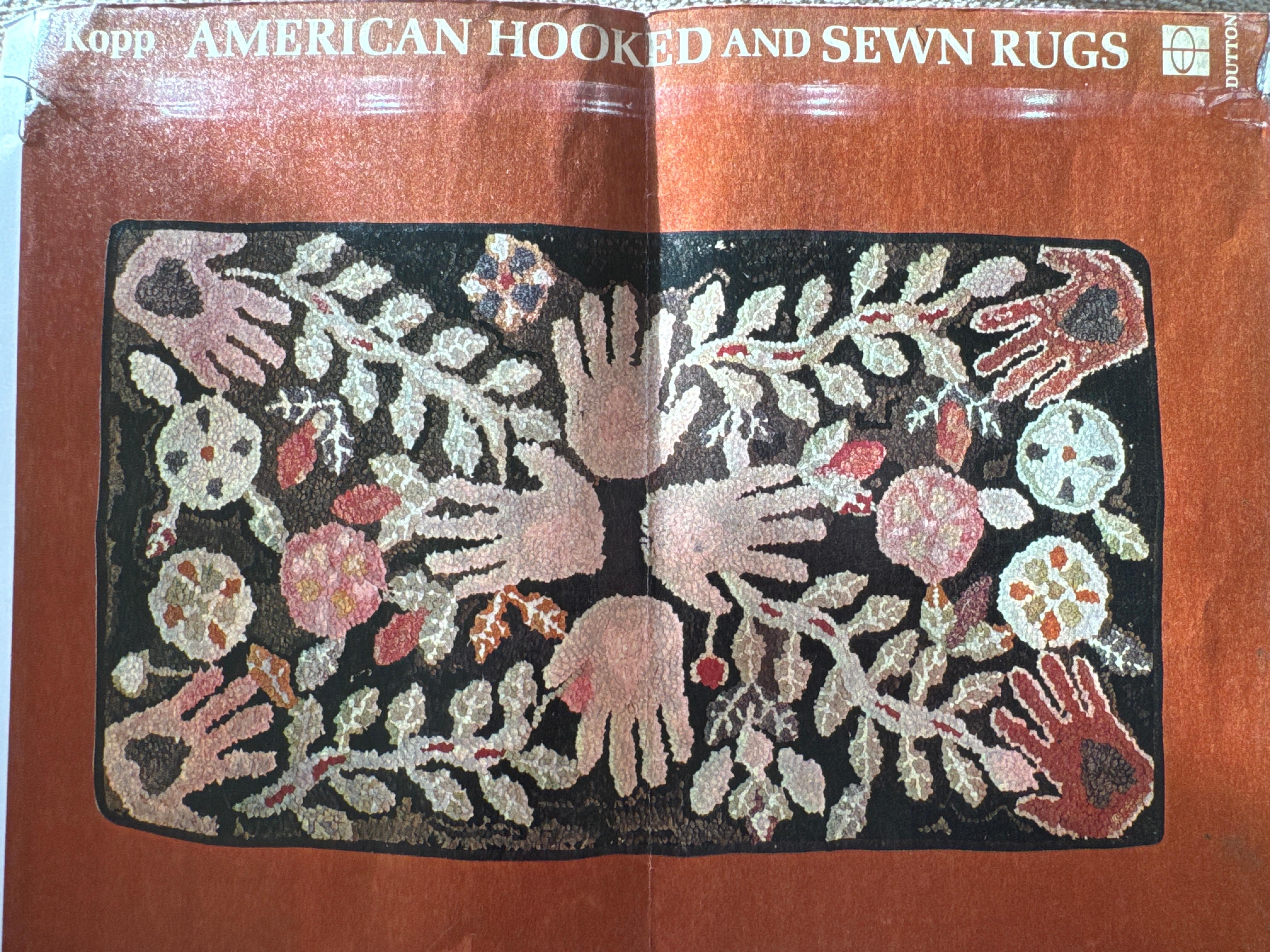 Hooked heart-in-hand rug is wool on burlap and has been mounted for hanging. The rug was part of a collection of Barbara Johnson and was illustrated in American Hooked and Sewn Rugs, Folk Art Underfoot, back cover and page 36. Current owner