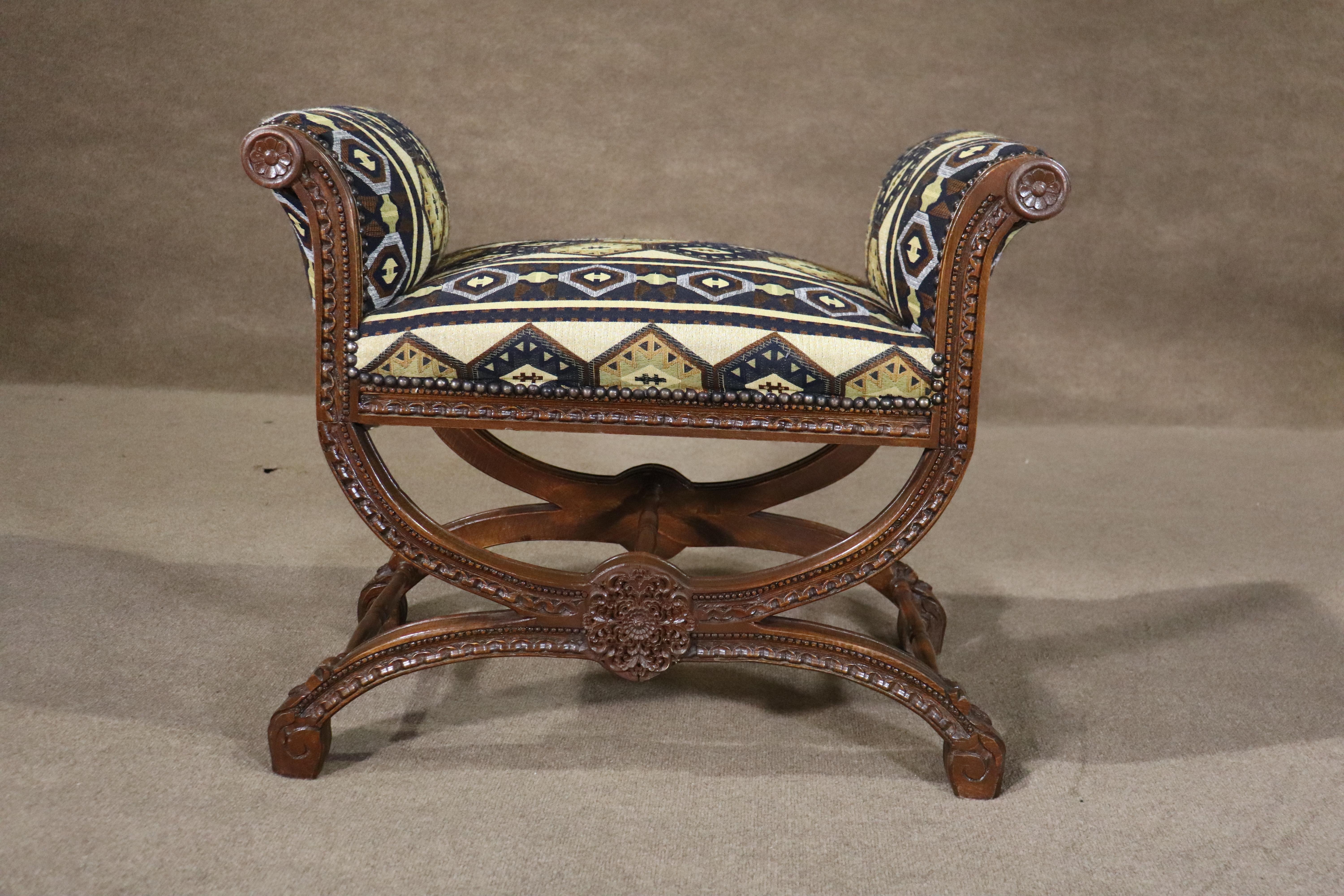 Antique carved frame bench with criss-cross base and scrolling arms. Upholstered seat and arms, with hand carved embellishments throughout.
Please confirm location NY or NJ