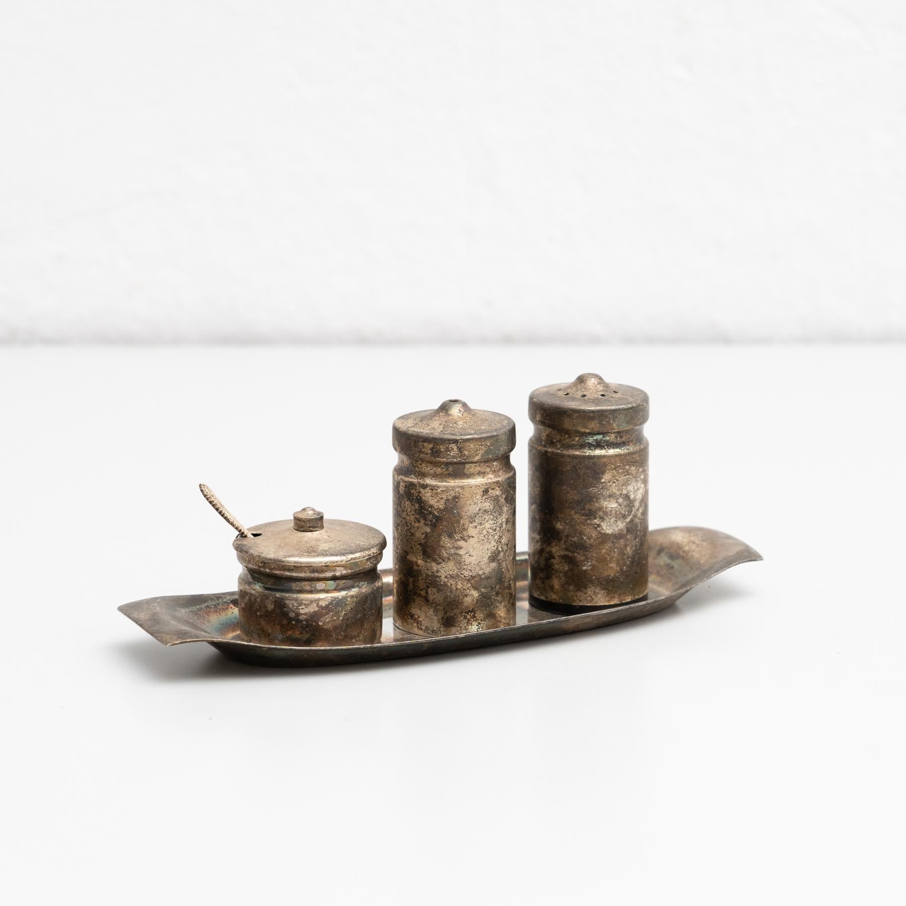 Antique Catalan metal cruet set.    Manufactured in Spain, circa 1940    In original condition, with minor wear consistent of age and use, preserving a beautiful patina.    Material:  Metal.