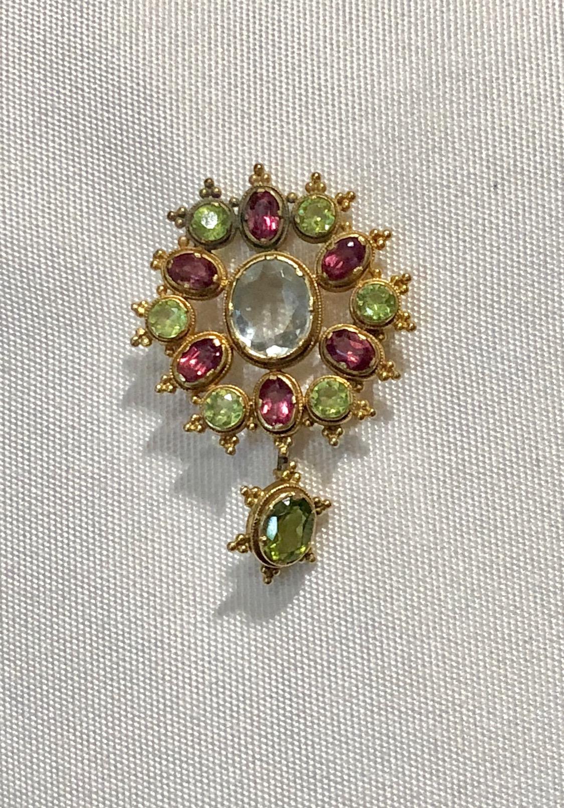 Semi precious stones pendant with brooch attachment, aquamarine, peridot,  pink tourmaline set in 18k gold. Detachable pendant piece. Ca 1940s
Stamped