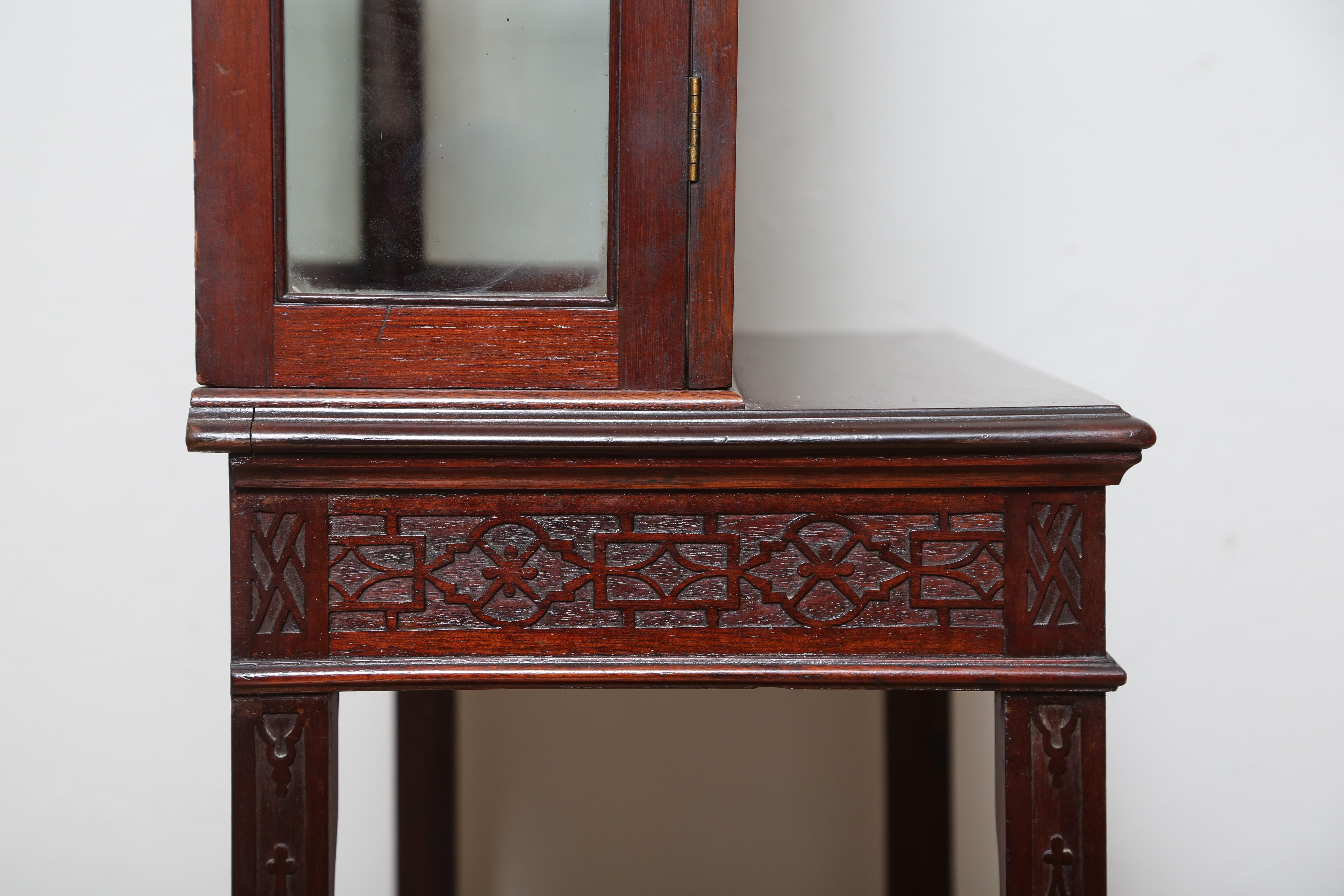 19th century Chinese Chippendale style display cabinet. Beautiful detail with three glass shelves plus the bottom shelf. Fitted with one drawer and bottom outside shelf. Interior illuminates. Topped with a pediment.
