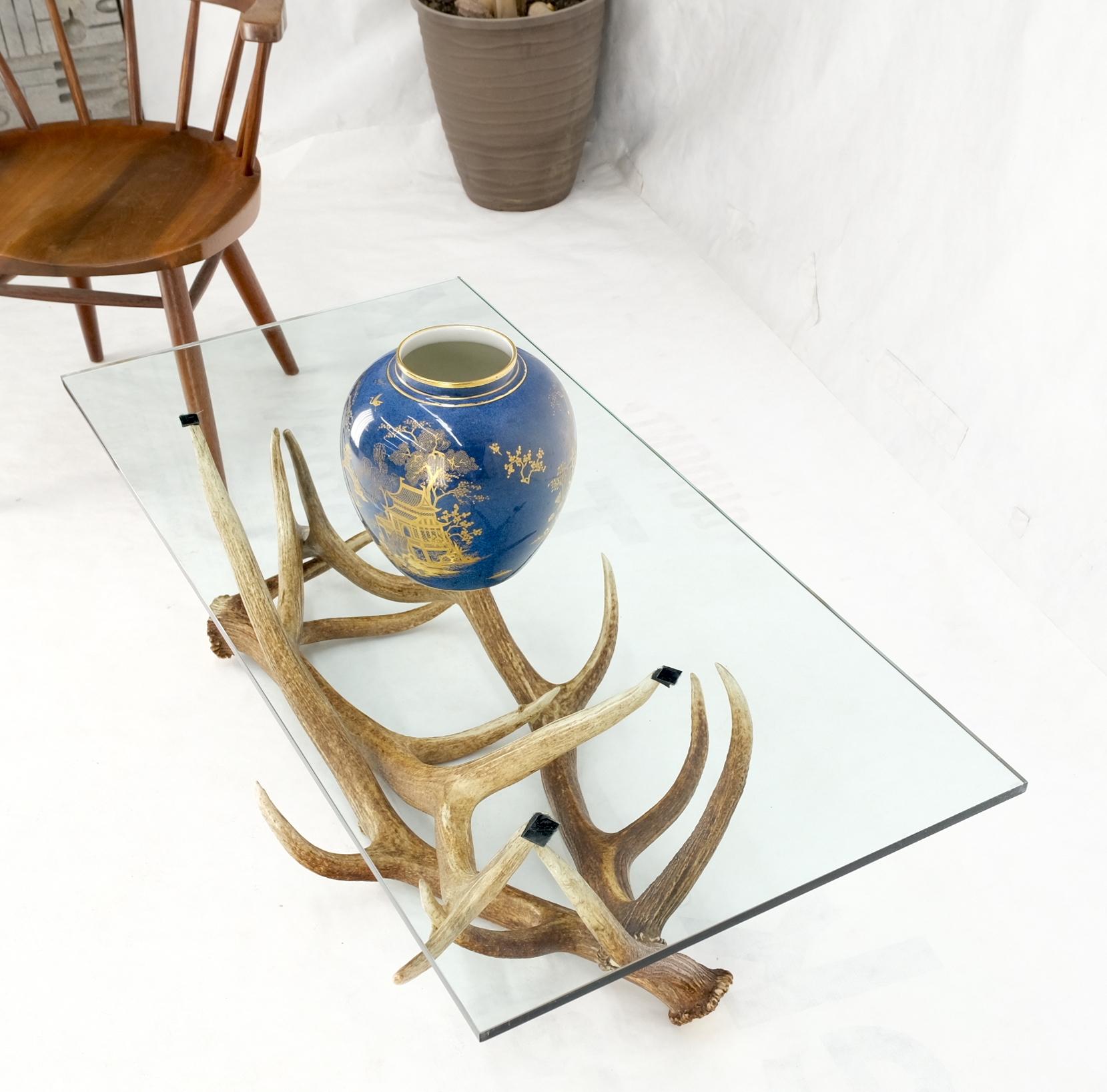Antler Grouping base glass rectangle top coffee table Folk Art Mid-Century Modern.
Artist signed. Glass top measures 1/2'' thick.