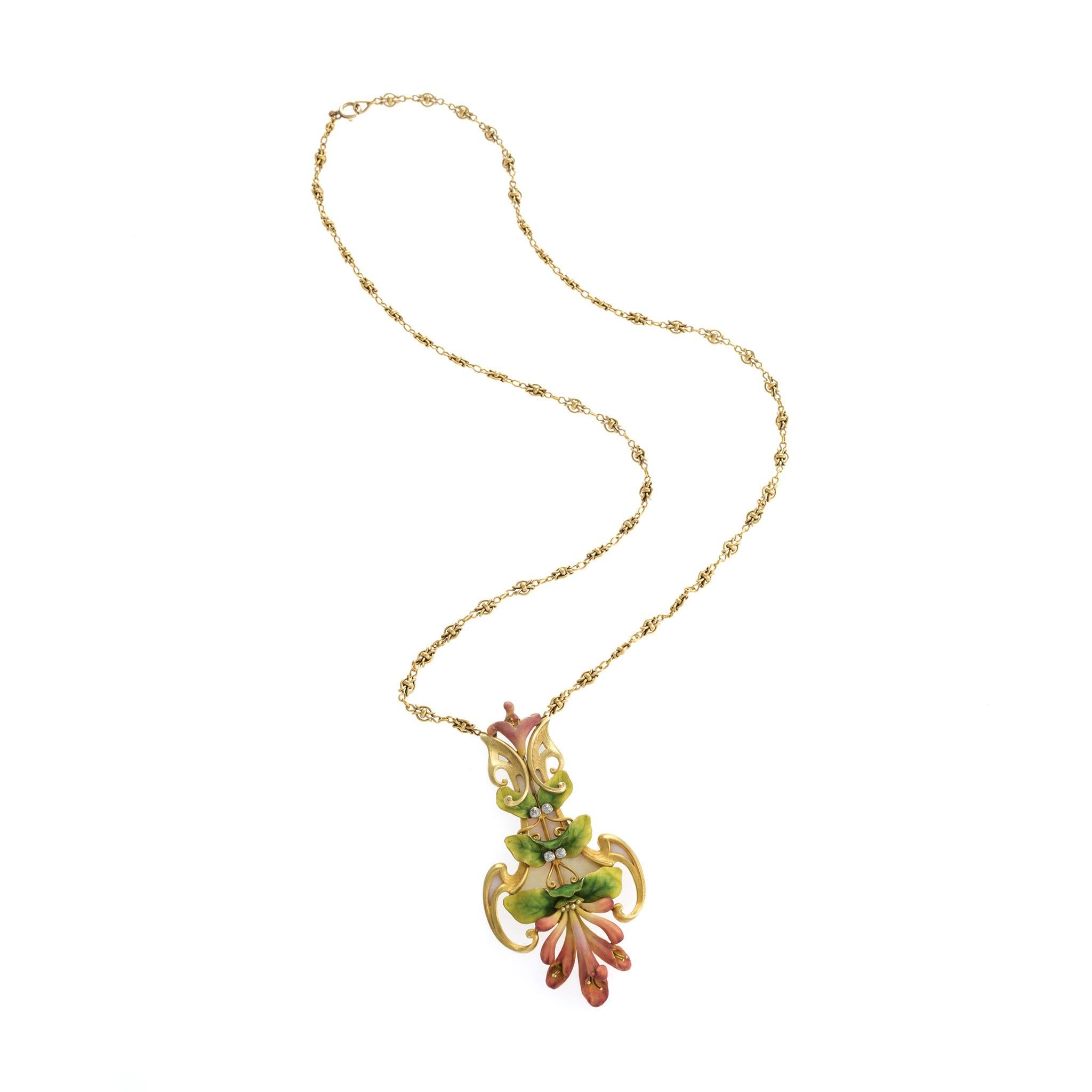 This gold, enamel, and diamond flower pendant necklace was created around 1900 by Parisian Art Nouveau jeweler, Antoine Bricteux. Designed as a polychrome trumpet flower in rose, green and cream enamel, the pendant is a cascade of petals, leaves and