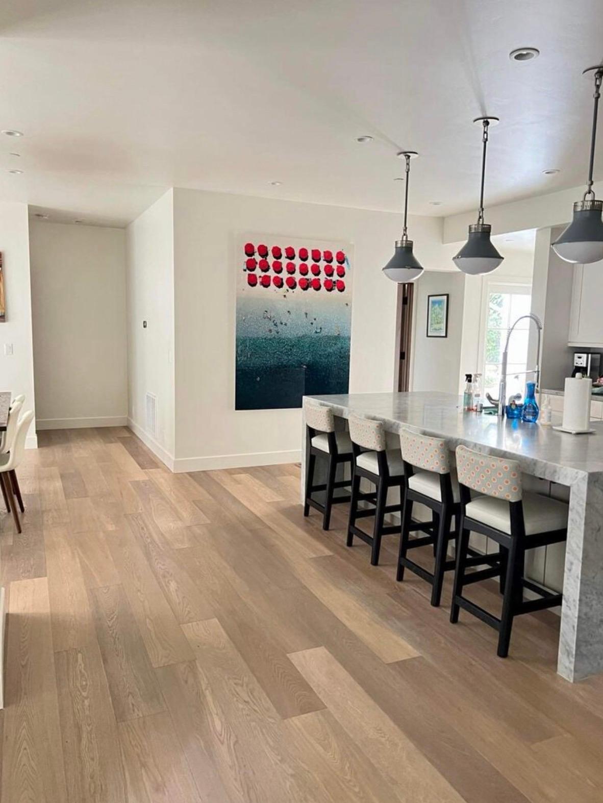 Appendendosi a un elicottero che si libra a 300 piedi di altezza, Antoine Rose cattura in modo unico gli Hamptons da un'angolazione di 90 gradi. Questo pezzo è un'istantanea di attività condivise in spiaggia, con accessori colorati e una splendida