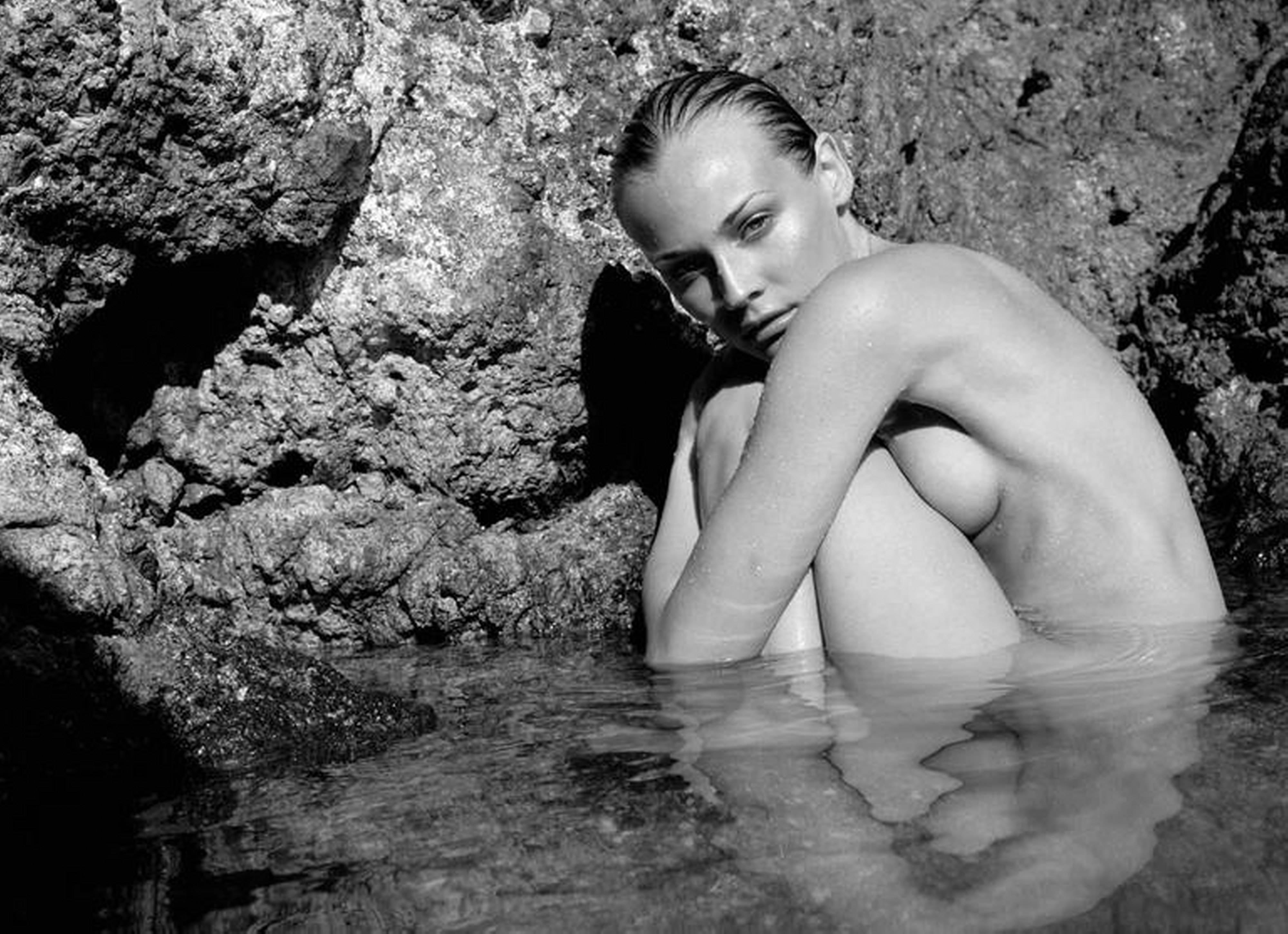 Antoine Verglas Black and White Photograph - Diane Kruger naked in the sea in front of a cliff  