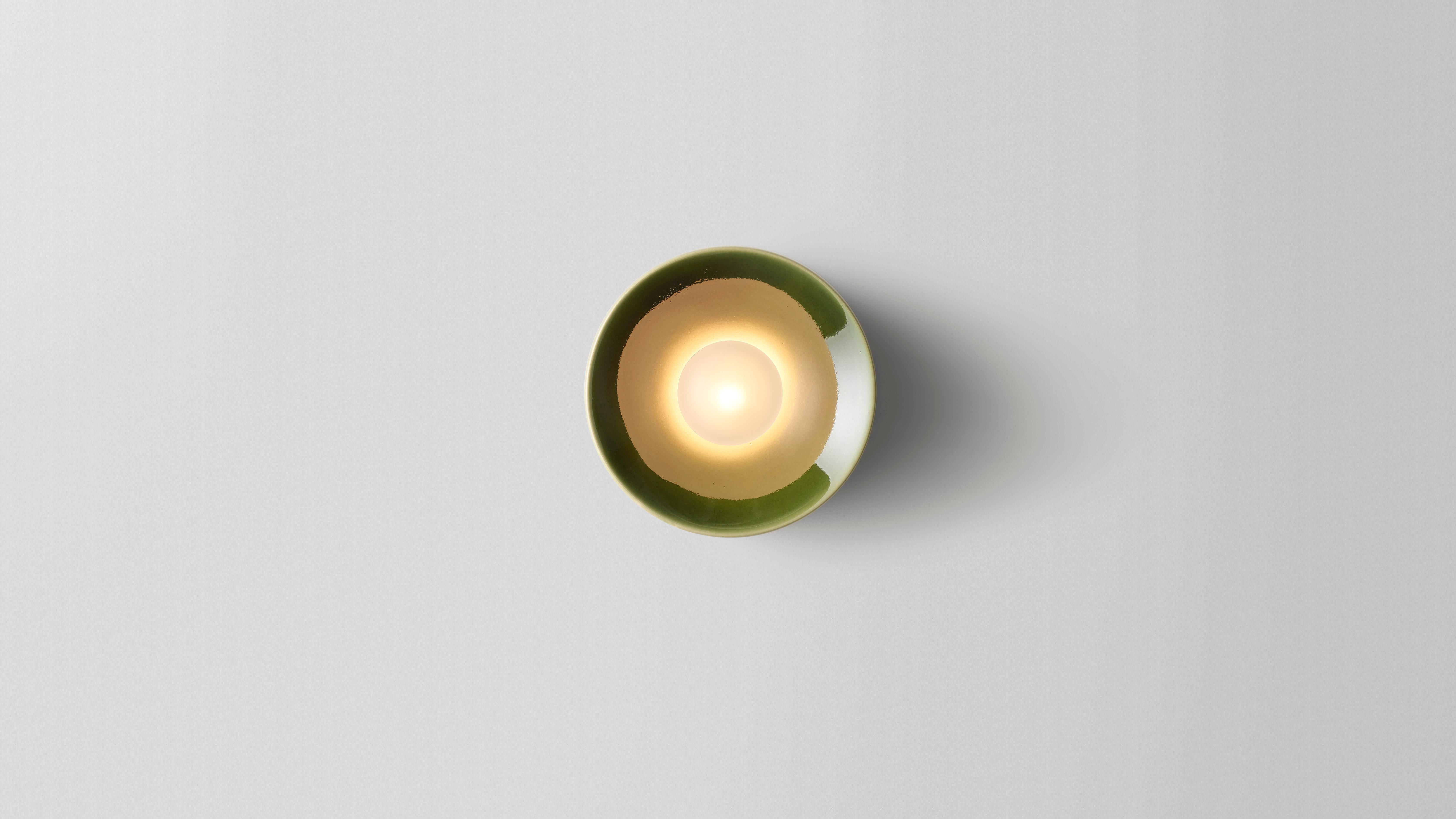 Anton ceramic green lamp by Volker Haug
Dimensions: Ø 18 x D 10 cm. 
Material: Cast Ceramic

Also available in different sizes: Ø 8, 13 or 18 cm. Please contact us.

Glaze: a selection of colors is available
Lamp: G9 LED (110V - 240V) or G4 LED