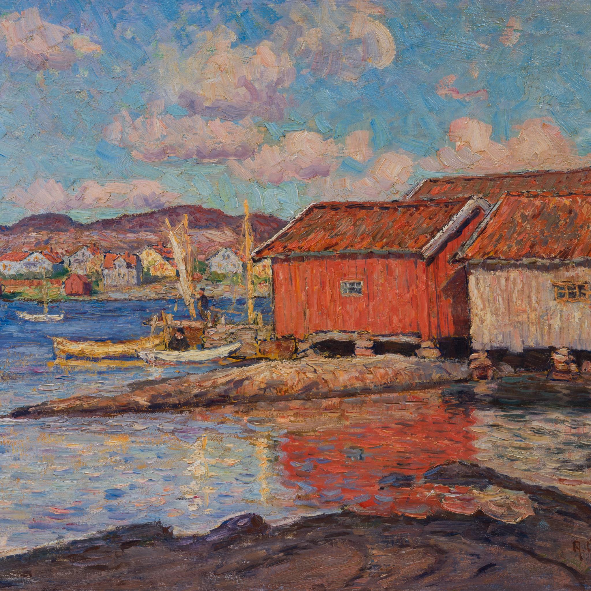 Anton Genberg’s coastal painting captures a tranquil harbor scene along Sweden’s west coast. In this 1923 oil painting, a cluster of weathered boathouses stands by the water’s edge, their rustic red facades contrasting with the cool blues of sea and