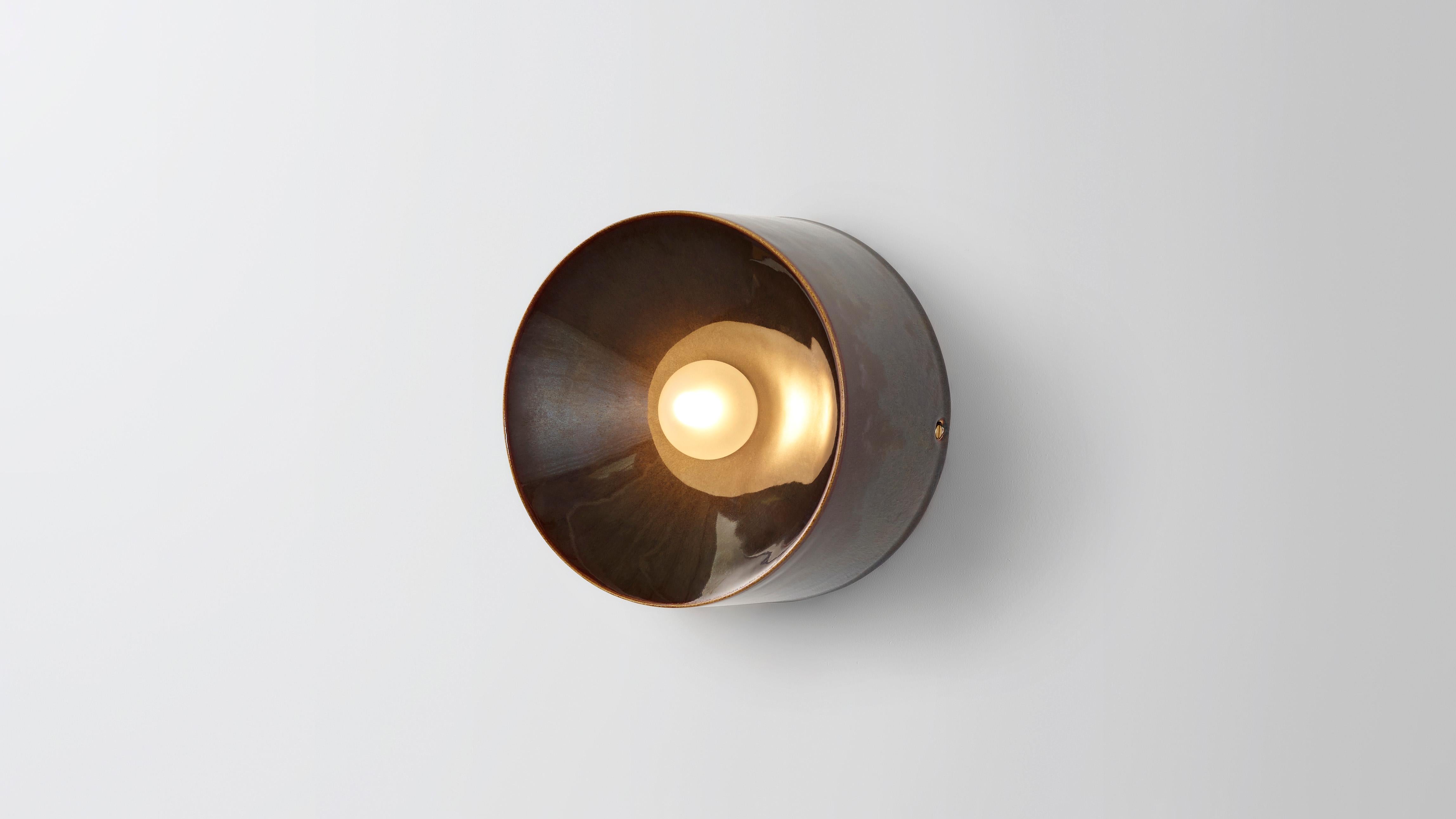 Anton in brown ceramic by Volker Haug 
Anton series
Dimensions: W 18 H 18 D 10.3 cm
Materials: Cast Ceramic
Glaze: Brown
Lamp: G9 LED (240V / 120V US). 12V option available
Glass Bulb : 4.5 cm ø, Frosted
Weight : 1.5kg

Form follows force. The Anton
