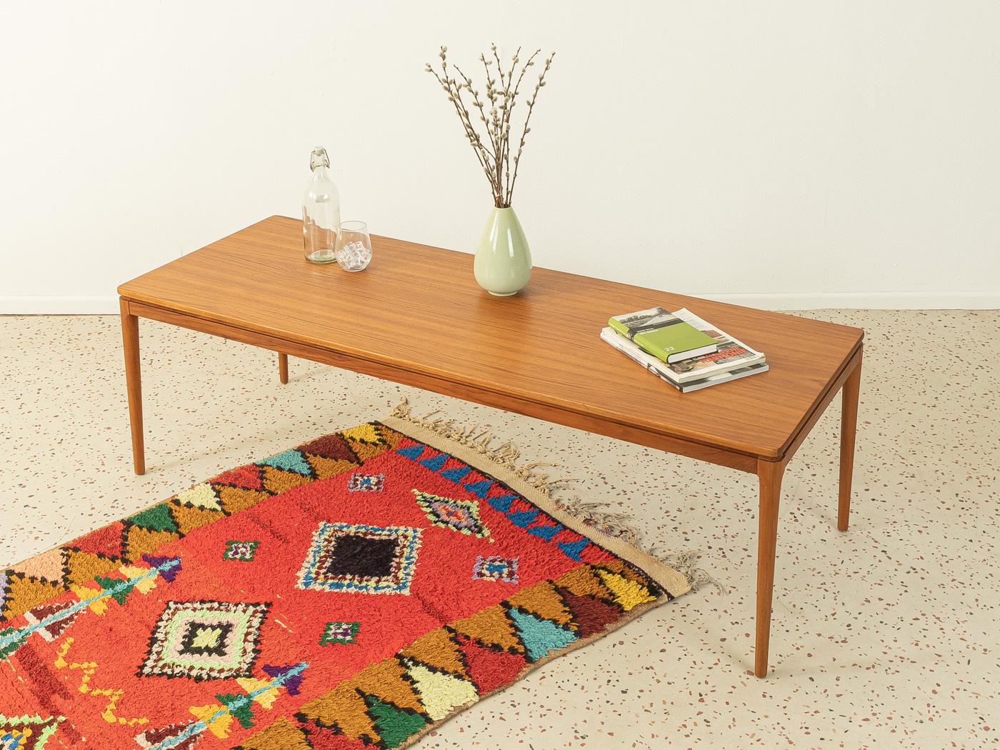 Rare coffee table from the 1960s by Anton Kildeberg Møbelfabrik. Solid frame in teak wood, a table top in teak veneer and a pull-out shelf with black Formica coating.

Quality Features:
- accomplished design: perfect proportions and visible