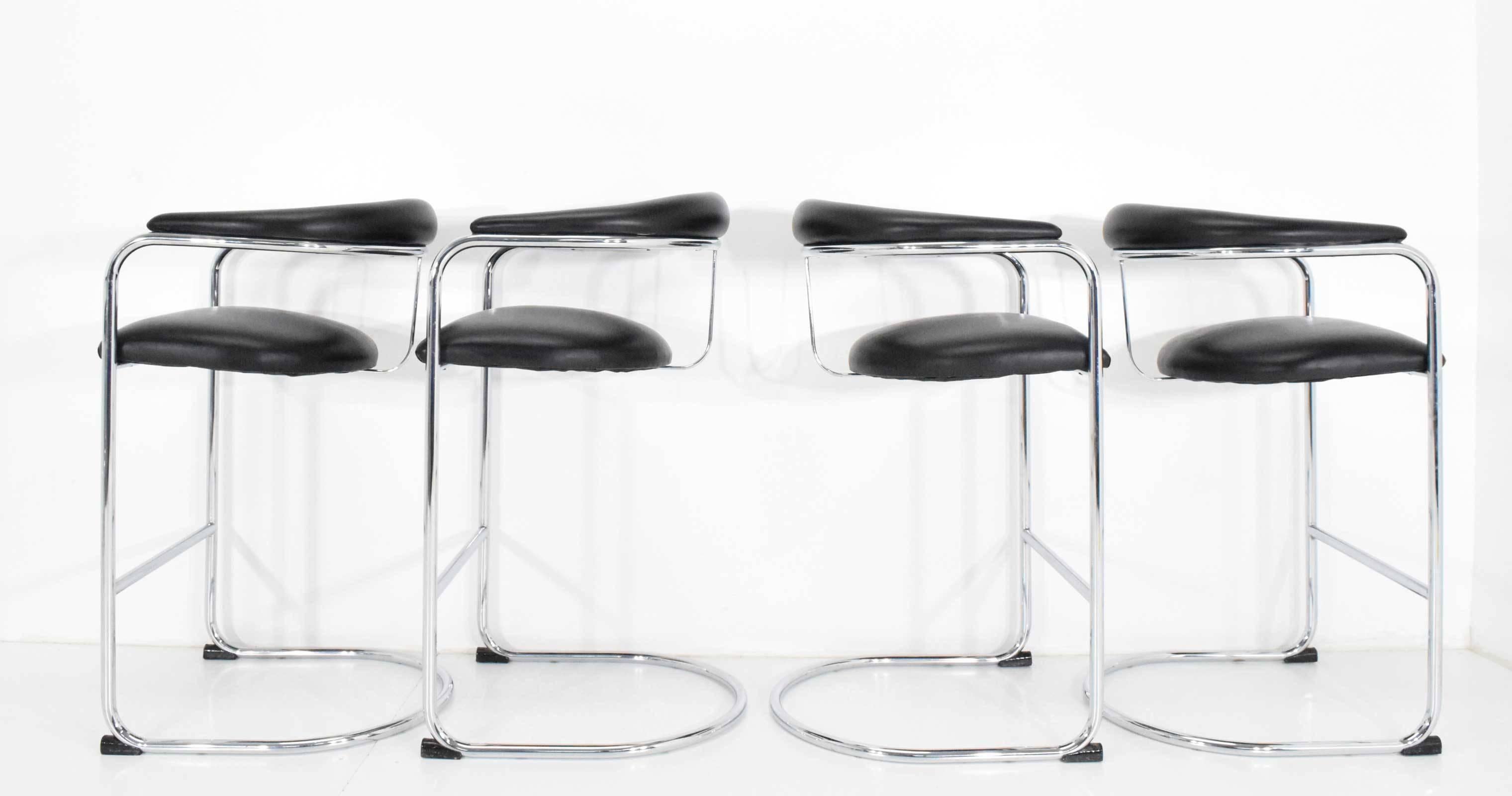 We have eight of these stools available. We also have another two in white under a separate listing. They are designed by Anton Lorenz for Thonet. Chairs are in beautiful condition with shiny chrome frames and a black faux leather seat and back. 