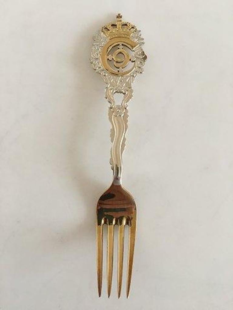 Anton Michelsen commemorative fork in gilded sterling silver from 1903.

For the occation of Christian IX 40 years as ruler (jubilee), 15 Nov 1903.
Designed by: Thorvald Bindesbøll.
 