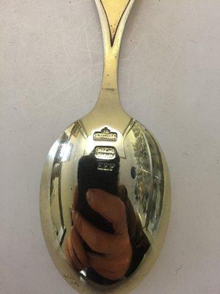 Anton Michelsen Commemorative spoon in gilded sterling silver from 1964.

For the occation of Princess Anne Marie & King Konstantain's Wedding, 18 Sep 1964.
Designed by: Erik Ellegaard Frederiksen.
 