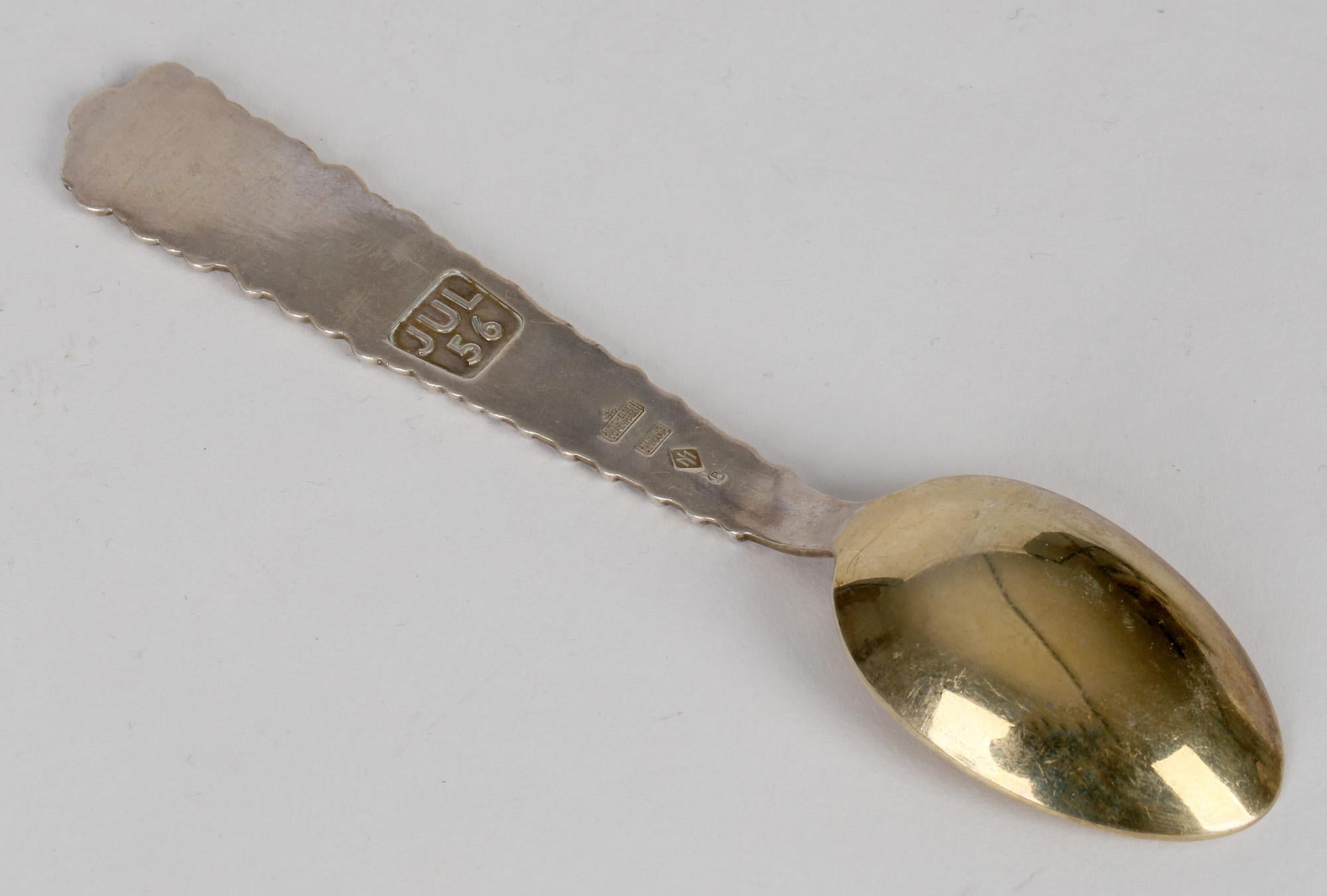 A very fine vintage mid-century Danish gilt silver spoon with inset enamel floral designs by Anton Michelsen and dated JUL 1956. The heavily made spoon has a gilded bowl with silver stem moulded in relief with small flower heads increasing in size