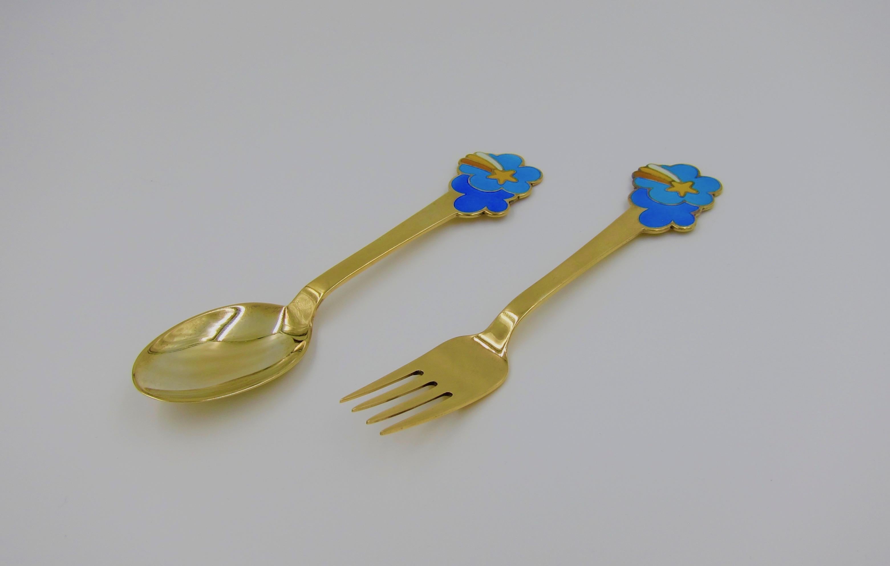 A Danish gilded sterling silver and enamel Christmas fork and spoon set from Anton Michelsen of Copenhagen, Denmark. Per Arnoldi (b. 1941) created this 