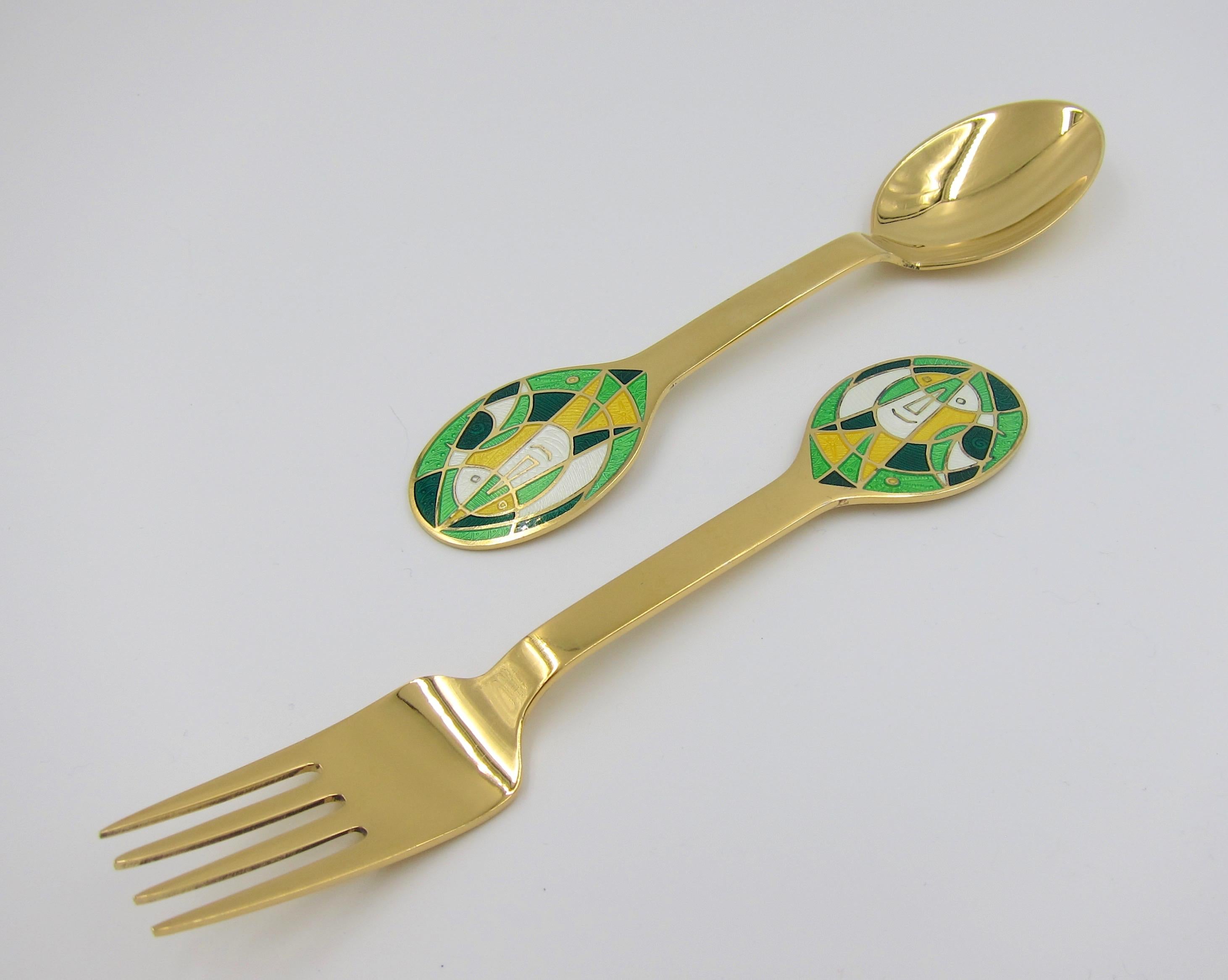 A Danish gilded sterling silver and enamel Christmas fork and spoon set from Anton Michelsen of Copenhagen, Denmark. Egill Jacobsen (1910-1998) created 