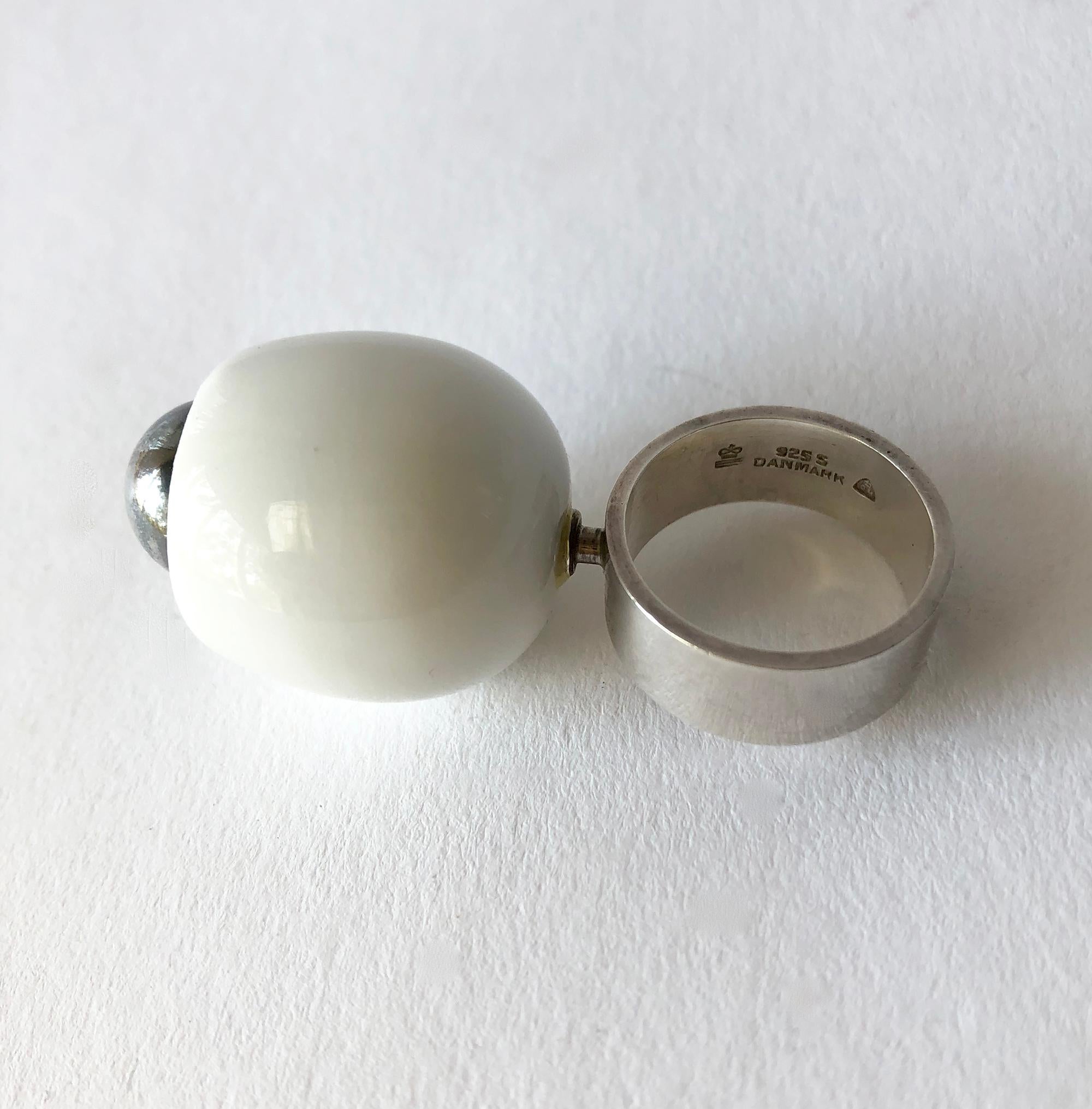 1960's Danish modernist Royal Bini ring created by Anton Michelsen for Royal Copenhagen of Denmark. Ring is a finger size 7 and is made up of a porcelain egg shaped cup and a large sterling silver ball centered within. Ring sits about 1 1/4