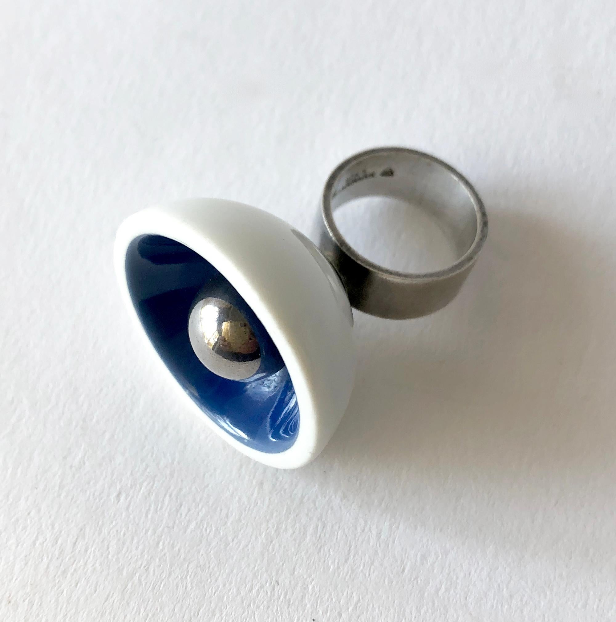1960's Danish modernist Royal Bini ring created by Anton Michelsen for Royal Copenhagen of Denmark. Ring is a finger size 5.75 to 6 and made up of a porcelain cup with royal blue interior accent and a large ball of sterling silver centered within. 