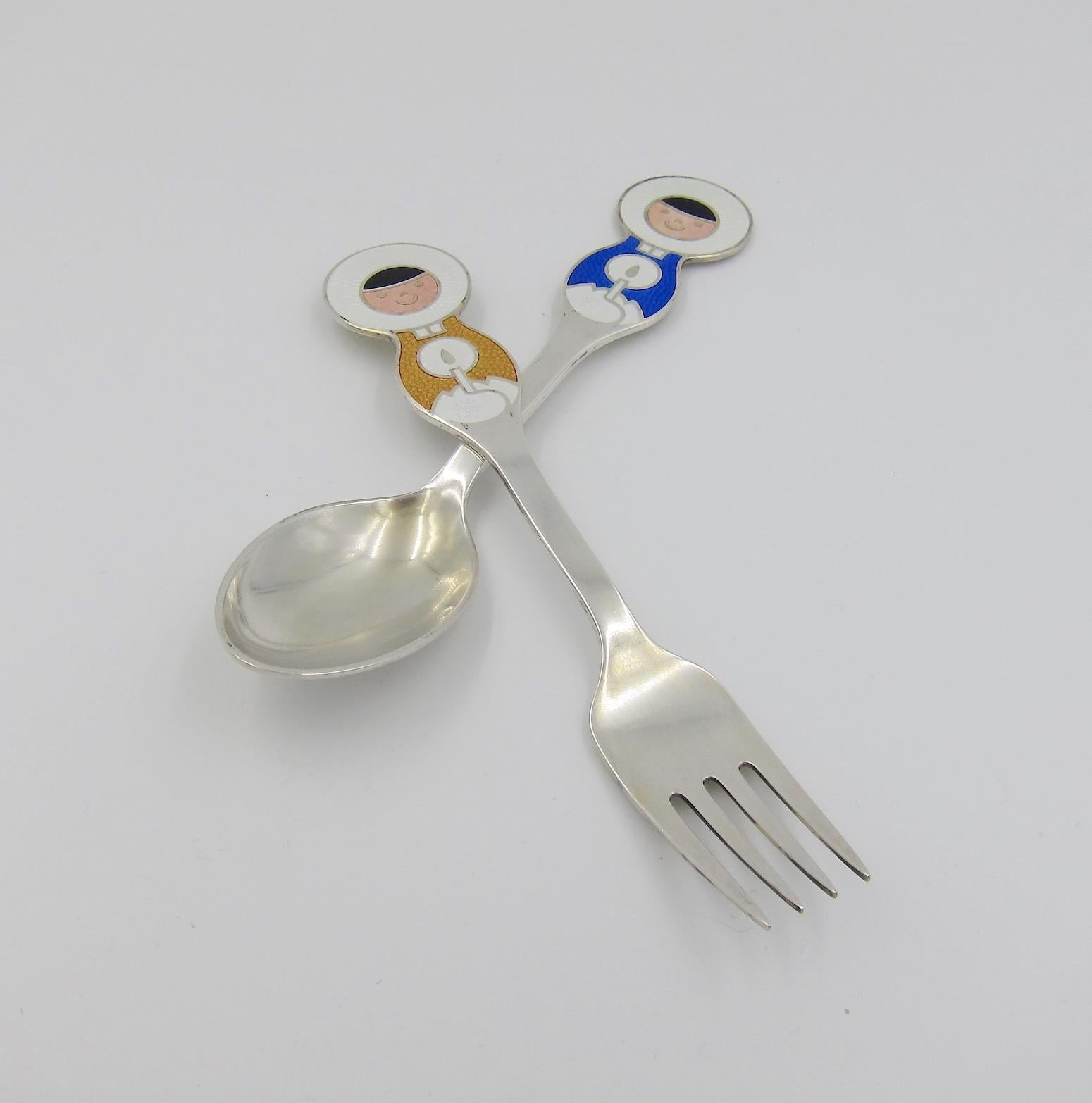 A Danish sterling silver and enamel Christmas fork and spoon set from Anton Michelsen of Copenhagen, Denmark. Artist Ib Antoni (1929-1973) created this 