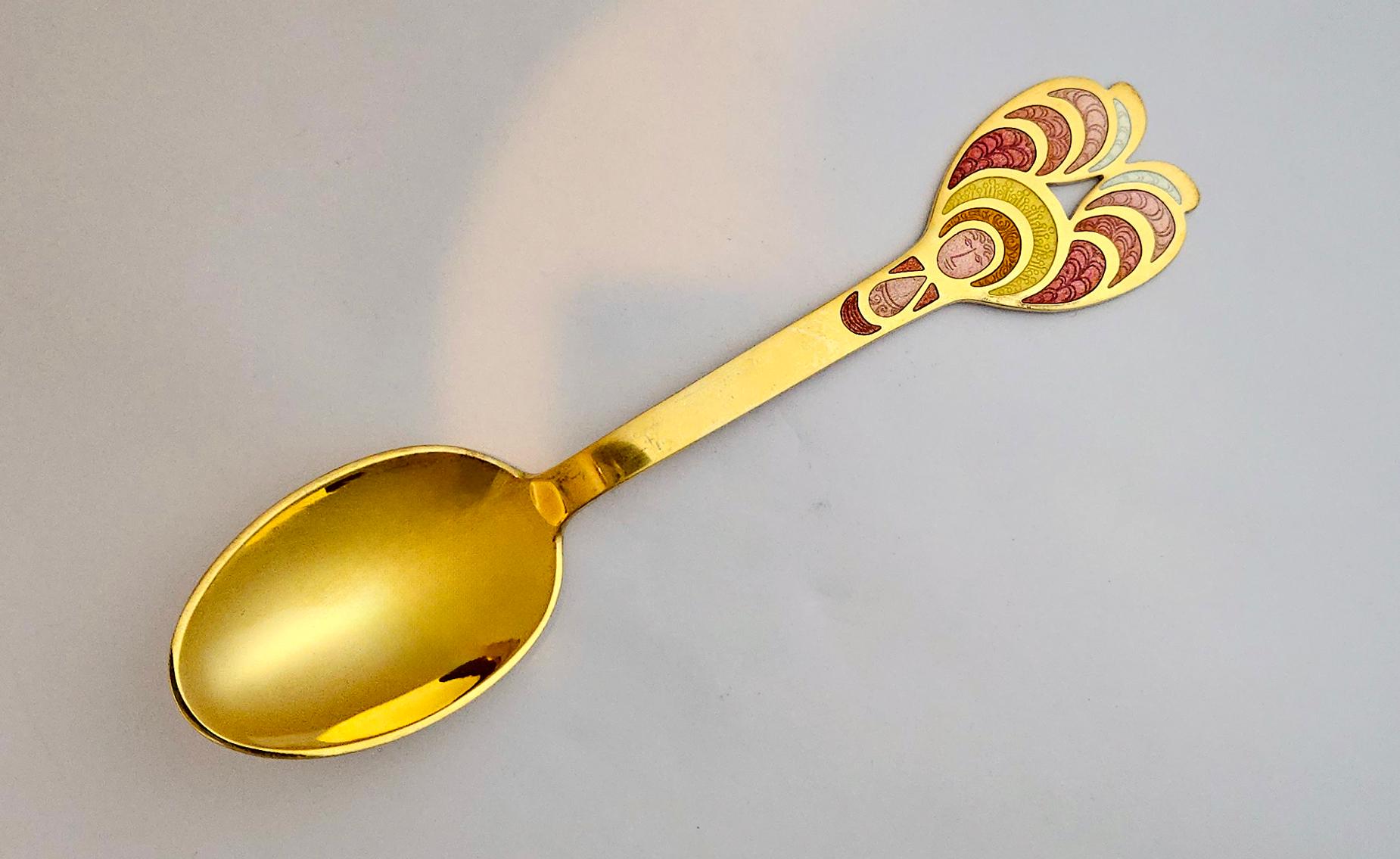 Anton Michelsen Sterling Silver Gilt Christmas Spoon,
The Artisan Bjørn Wiinblad is the Designer,
1972

The 1972 Anton Michelsen Christmas Spoon is sterling silver gilt with an enamel handle. It was designed Bjørn Wiinblad. The shaped handle of the