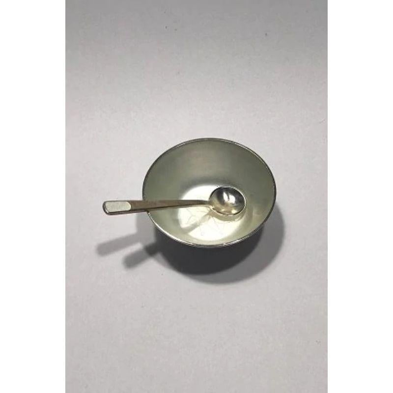 Anton Michelsen sterling silver salt cellar and salt spoon (White enamel) 

Measures 5 cm(1 31/32 in) Spoon 6 cm (2 23/64 in) Combined Weight 19 gr/0.67 oz.
