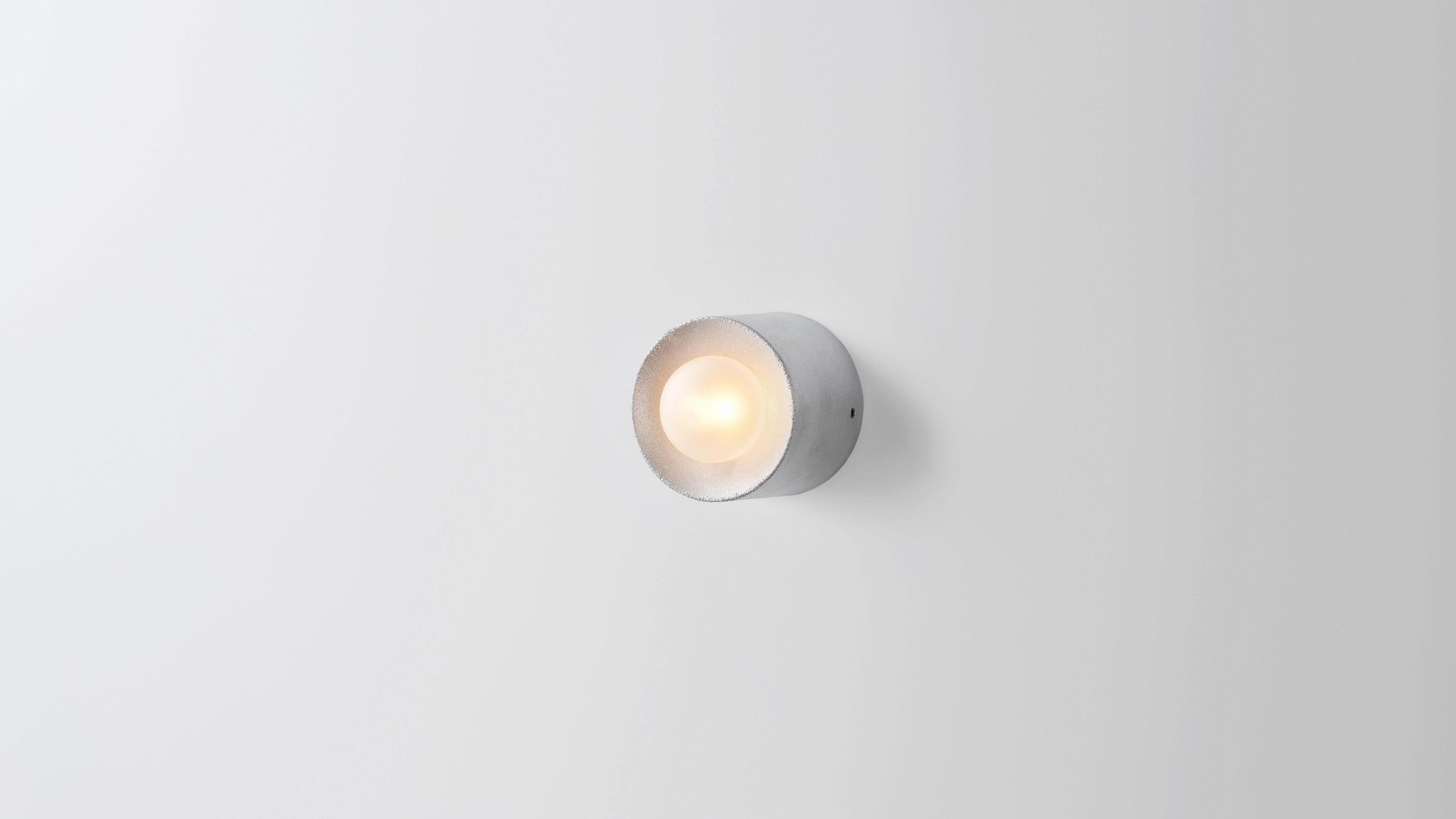 Anton micro in aluminium by Volker Haug 
Anton series
Dimensions: Ø 8 x D 6.5 cm.
Materials: Cast aluminium
Finish: Raw
Lamp: G9 LED (240V / 120V US). 12V option available.
Glass bulb: 4.5 cm ø, Frosted
Weight: 1kg

Anton Micro is the smallest in
