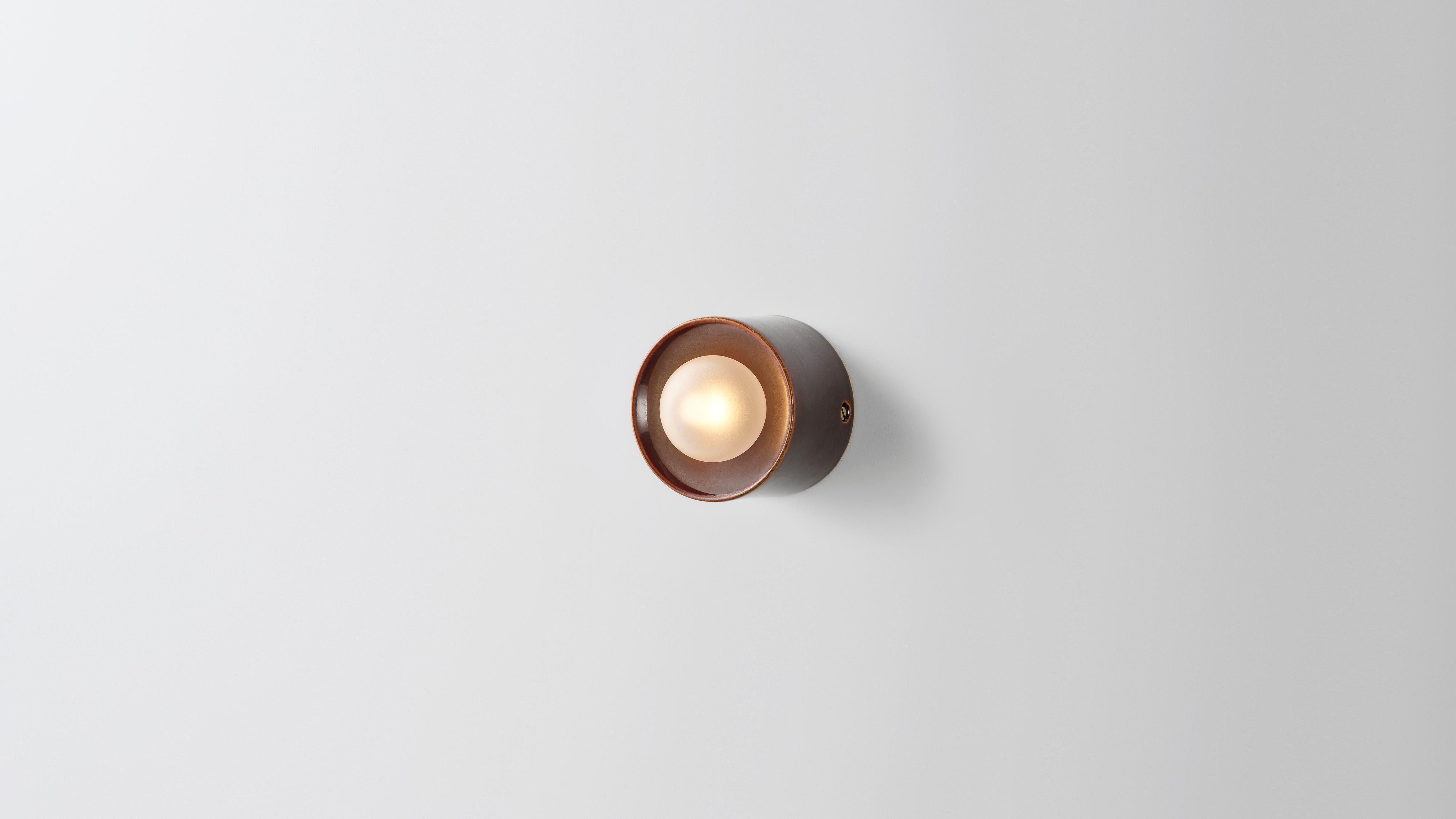 Anton Micro in brown ceramic by Volker Haug 
Anton series
Dimensions: W 8 H 8 D 6.3 cm
Materials: Cast Ceramic
Glaze: Brown
Lamp: G9 LED (240V / 120V US). 12V option available
Glass Bulb : 4.5 cm ø, Frosted
Weight : 1kg

Anton Micro is the smallest
