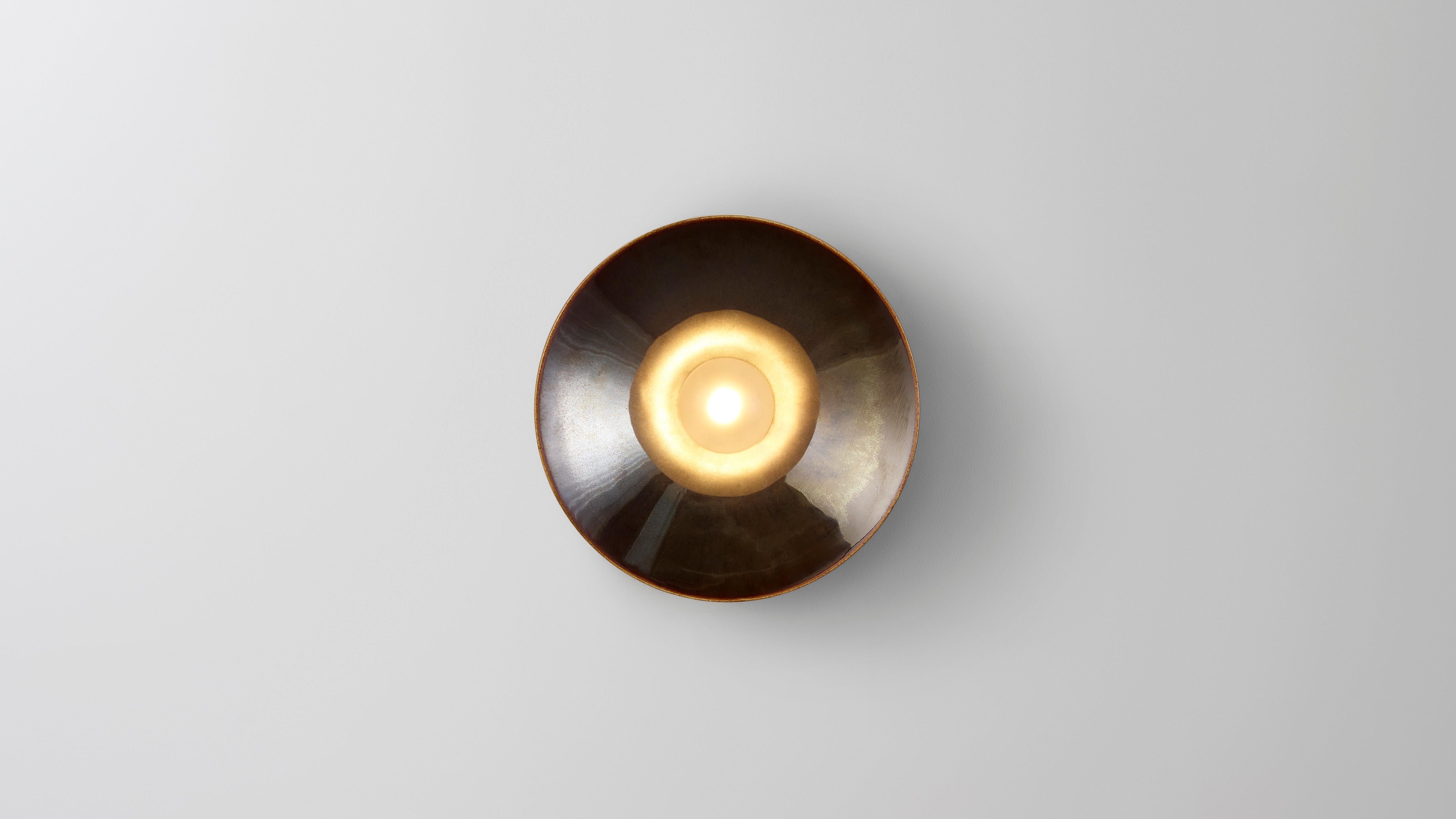 Anton Mini in brown ceramic by Volker Haug.
Anton series
Dimensions: W 13, H 13, D 8.3 cm
Materials: Cast ceramic
Glaze: Brown
Lamp: G9 LED (240V / 120V US). 12V option available
Glass bulb: 4.5 cm Ø, Frosted
Weight: 1kg

Anton Mini (Ø13
