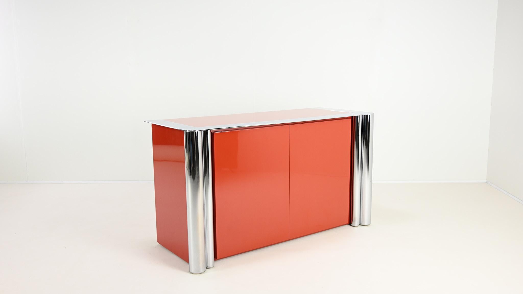 Antonello Mosca, sideboard for Cinova, Lacquer and Chrome, Italy C.1969

Rare sideboard, two doors variant of the model 1008, designed by Antonello Mosca for Cinova. Coral lacquered wood with chromed metal front legs and top frame surrounding a