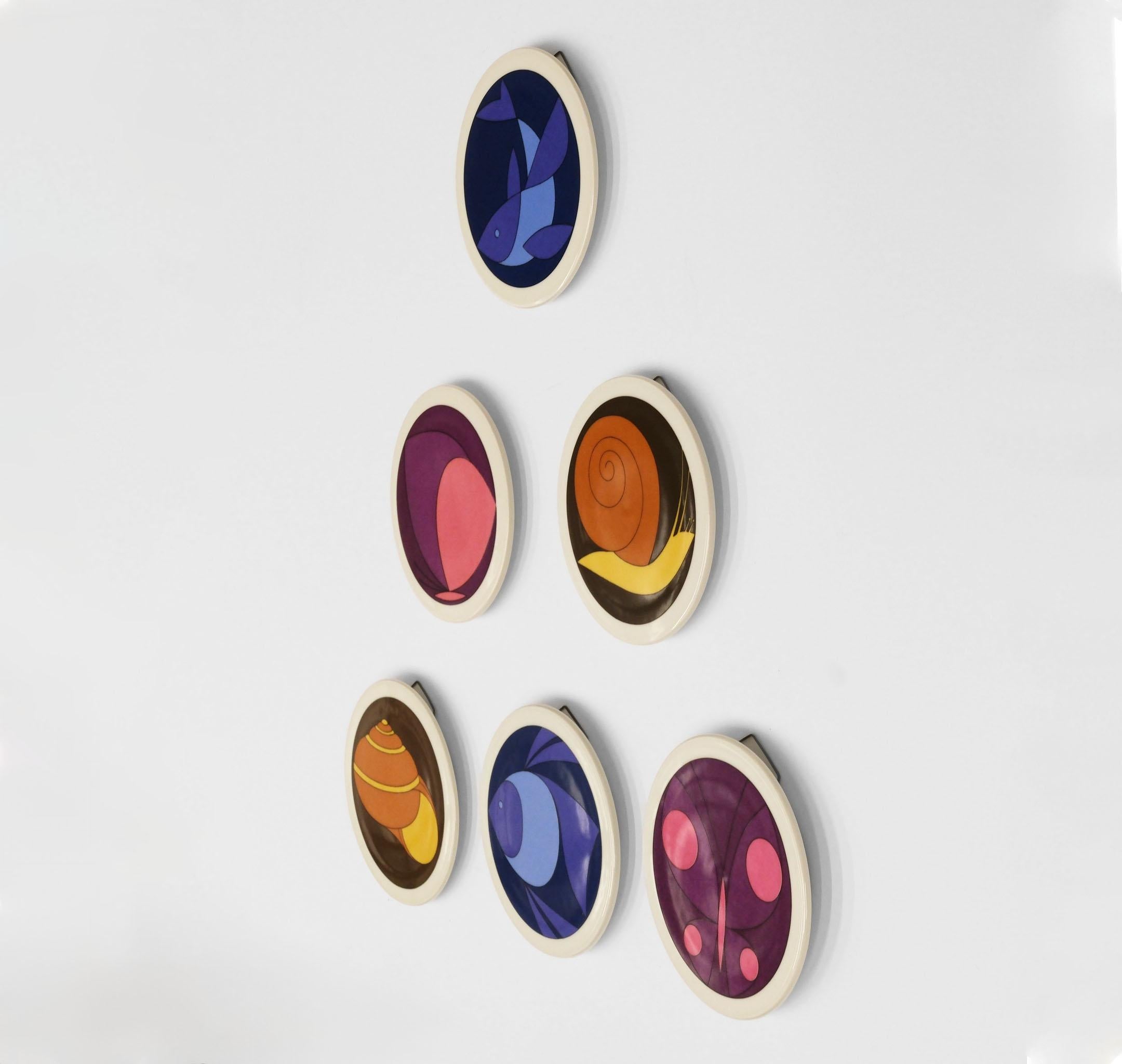 A collection of six Bing & Grondahl porcelain wall plaques, by Antoni for Royal Copenhagen. Circa 1970.

Each one has colourful geometric transfer-printed semi-abstract design in various tones.

In very good condition, with no damage. Can also be