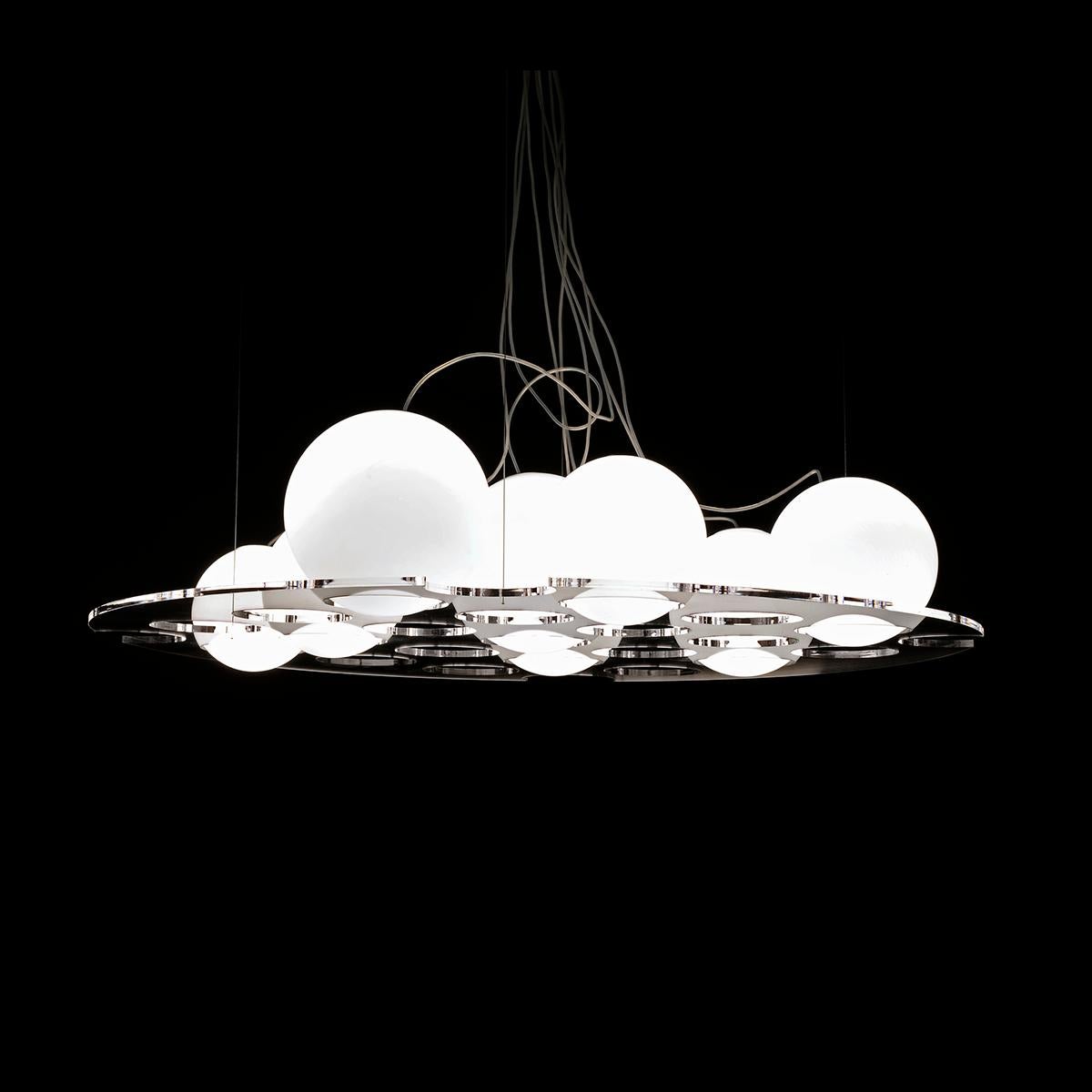 Suspension lamp 'Lyndon' designed by Antonia Astori & Nicola De Ponti.
Suspension lamp giving diffuse light. Support plateau in transparent laser-finished and polished PMMA. Globes in opaline opaque blown glass in different sizes. Manufactured by