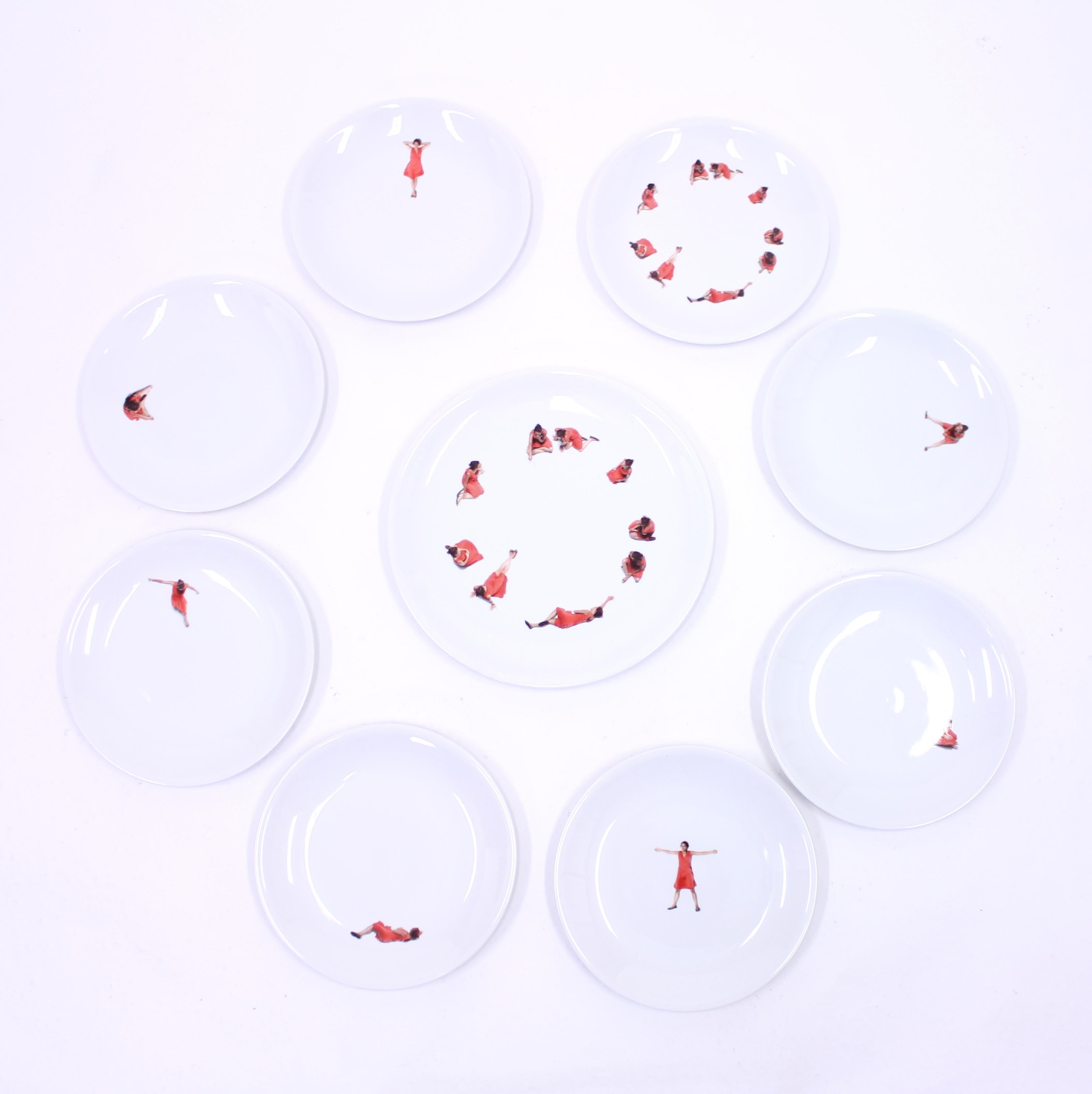 Set of 9 plates (8 dining plates and 1 serving plate) designed by Antonia Astori, with decorations in form of a girl in a red dress by Ron Gilad, from the White Snow Snow White collection, manufactured by Italian company Driade. This set is so