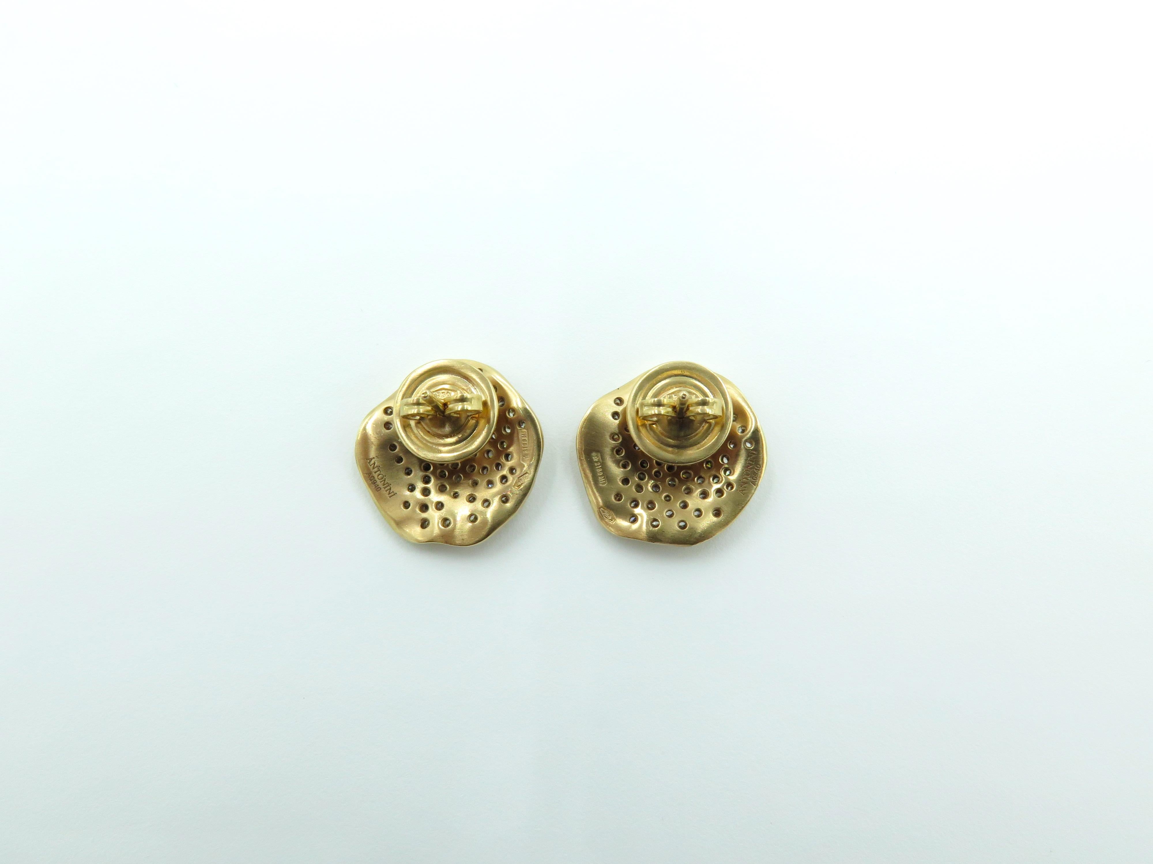 A pair of 18 karat rose gold and brown diamond Anniversary earrings. Antonini. Italian. Each matte gold disc of organic design, pave set with brown diamonds. Diamonds weigh approximately 1.50 carats total. Length is approximately 5/8 inches, gross