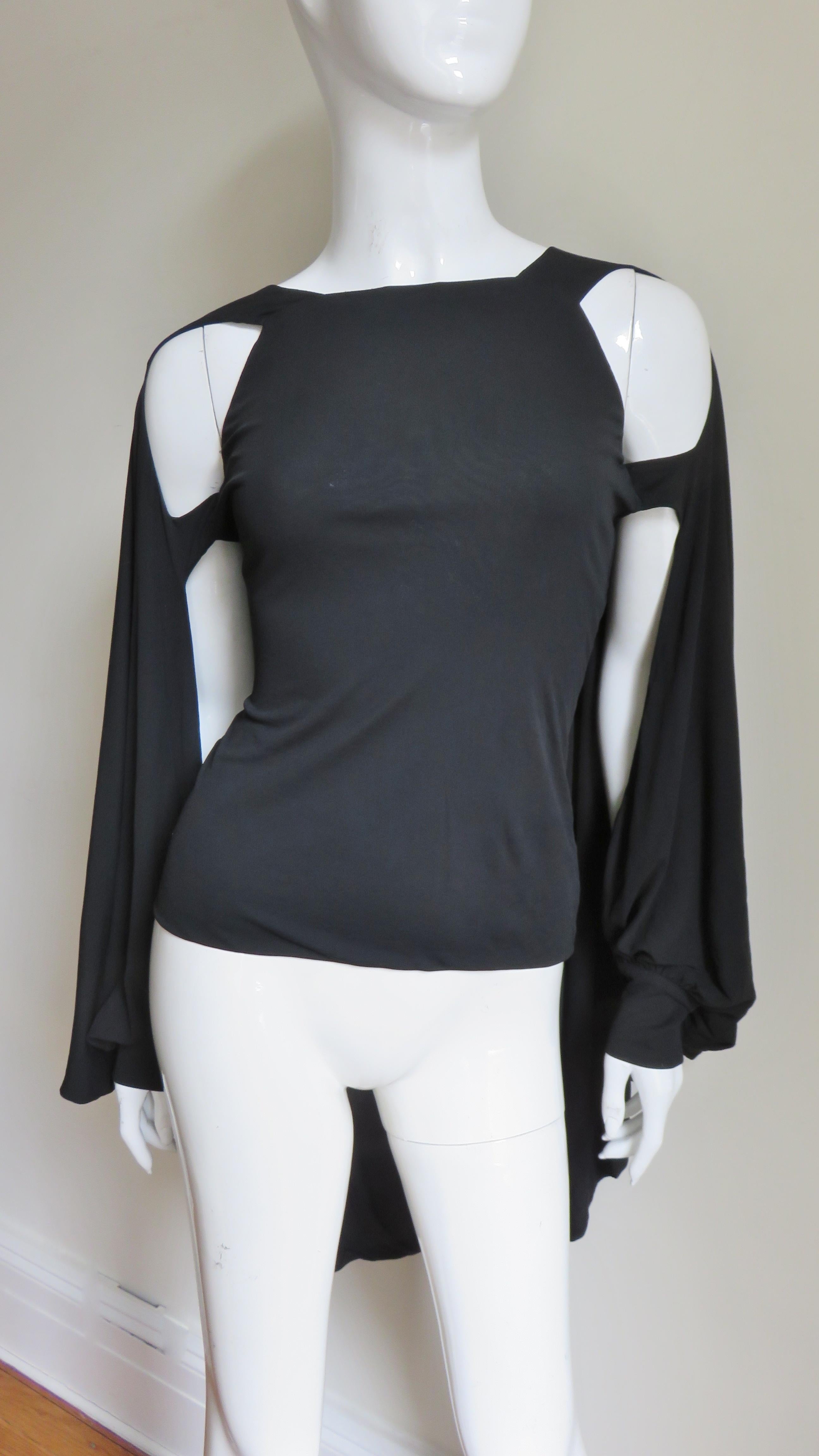 A fabulous fine black silk jersey top from Antonio Berardi.  It is a simply cut with open front sleeves which have 5 button cuffs and the back drapes into a cape. It slips on over the head. Stunning on.
Fits sizes Extra Small, Small, Medium. Marked