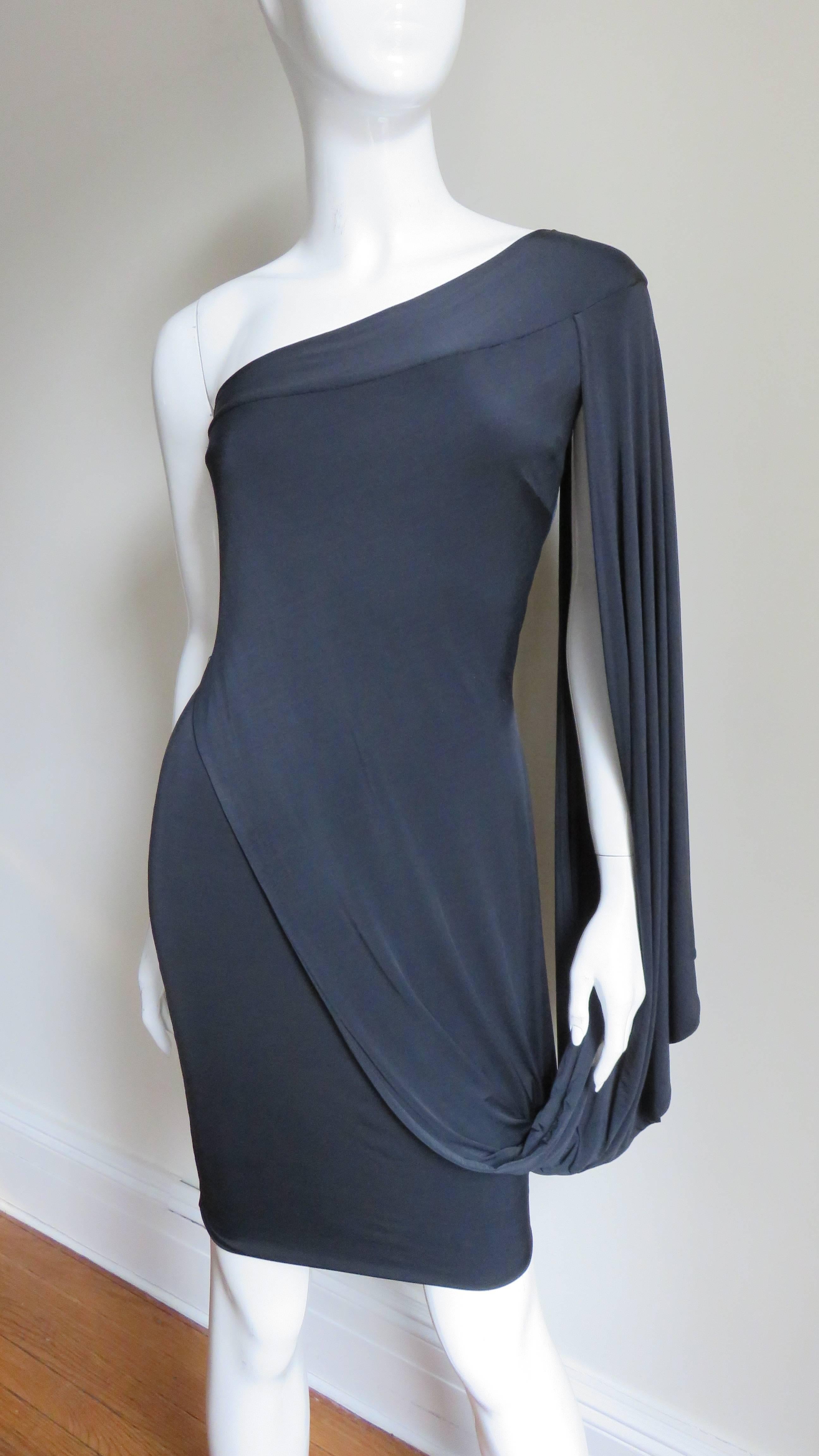 A beautiful black fine stretch silk dress from Antonio Berardi.  It is fitted with one shoulder from which a panel of fabric drapes along the top of the arm and the skirt front. It slips on and is lined in the same fabric.   
Fits sizes Extra Small,