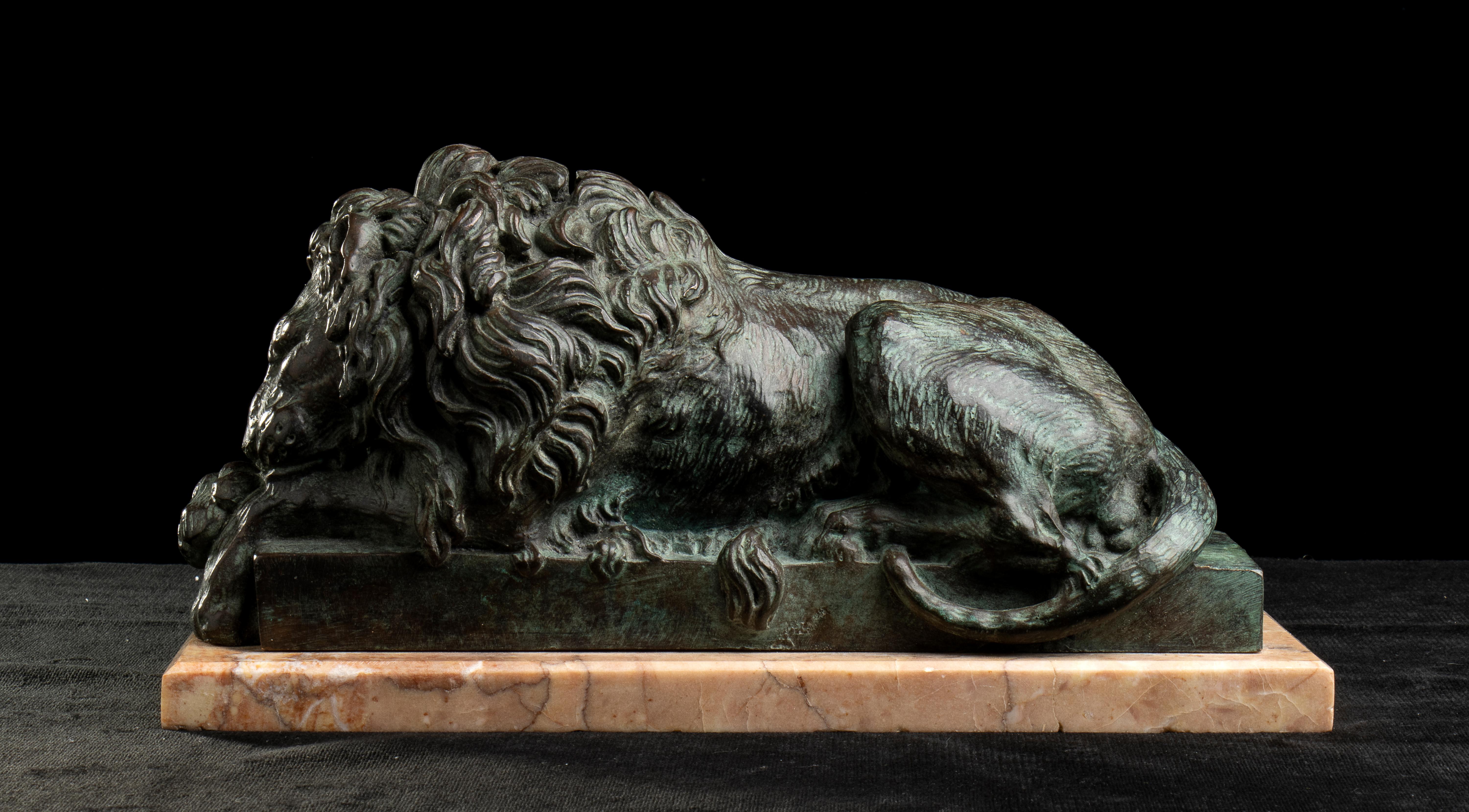 An impressive and important pair of grand tour sculptures of Lions in the manner of Antonio Canova, carved in bronze and resting on a marble base. The work, depicting a sleeping lion, in correlation with the other lion, this time awake, currently