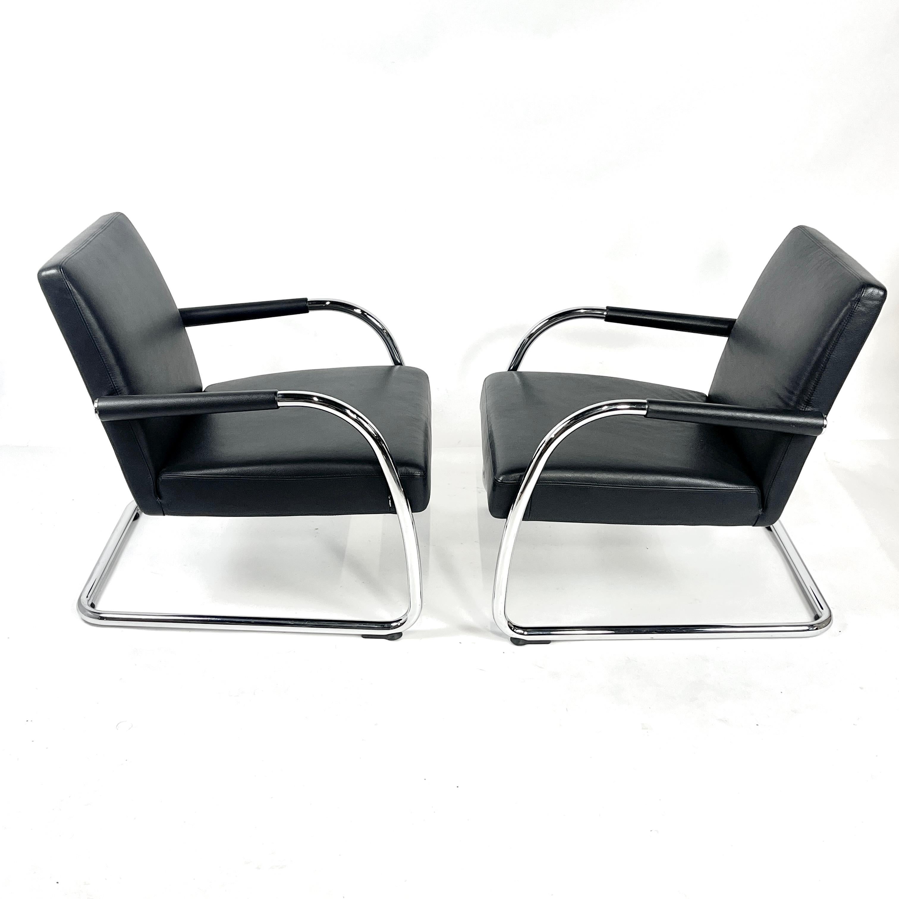 Stunning and elegant cantilevered lounge chairs designed by Antonio Citterio for Vitra. Textured leather is soft yet exteremely durable. These chairs will last a lifetime! Chromed cantilevered frame and accents complete the simple yet elegant