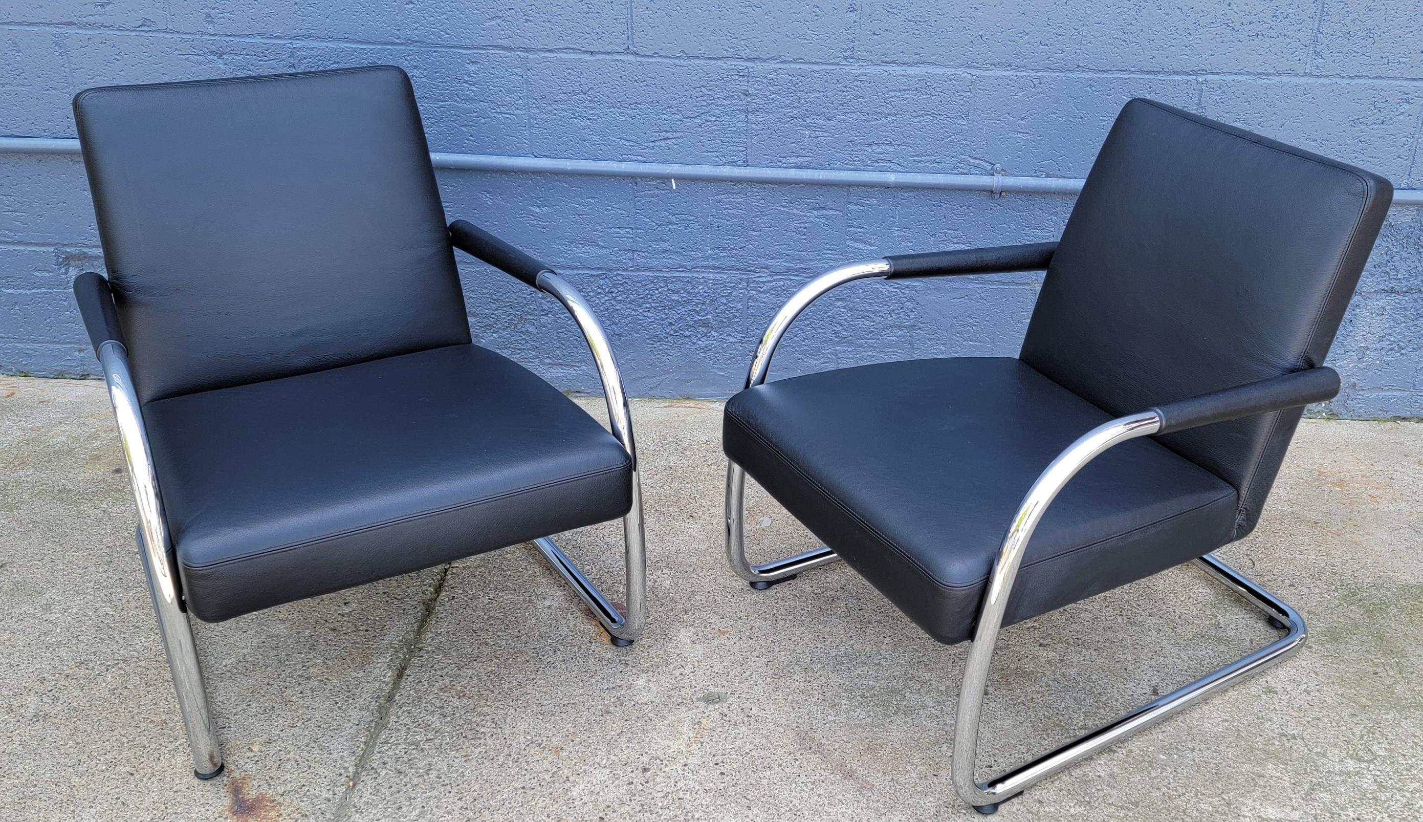 A pair of cantilevered tubular steel chrome and leather lounge chairs designed by Antonio Citterio for Vitra, Italy. Fine original condition with very minor signs of use. Polished chrome frames with black leather upholstery. Retain Vitra labels.