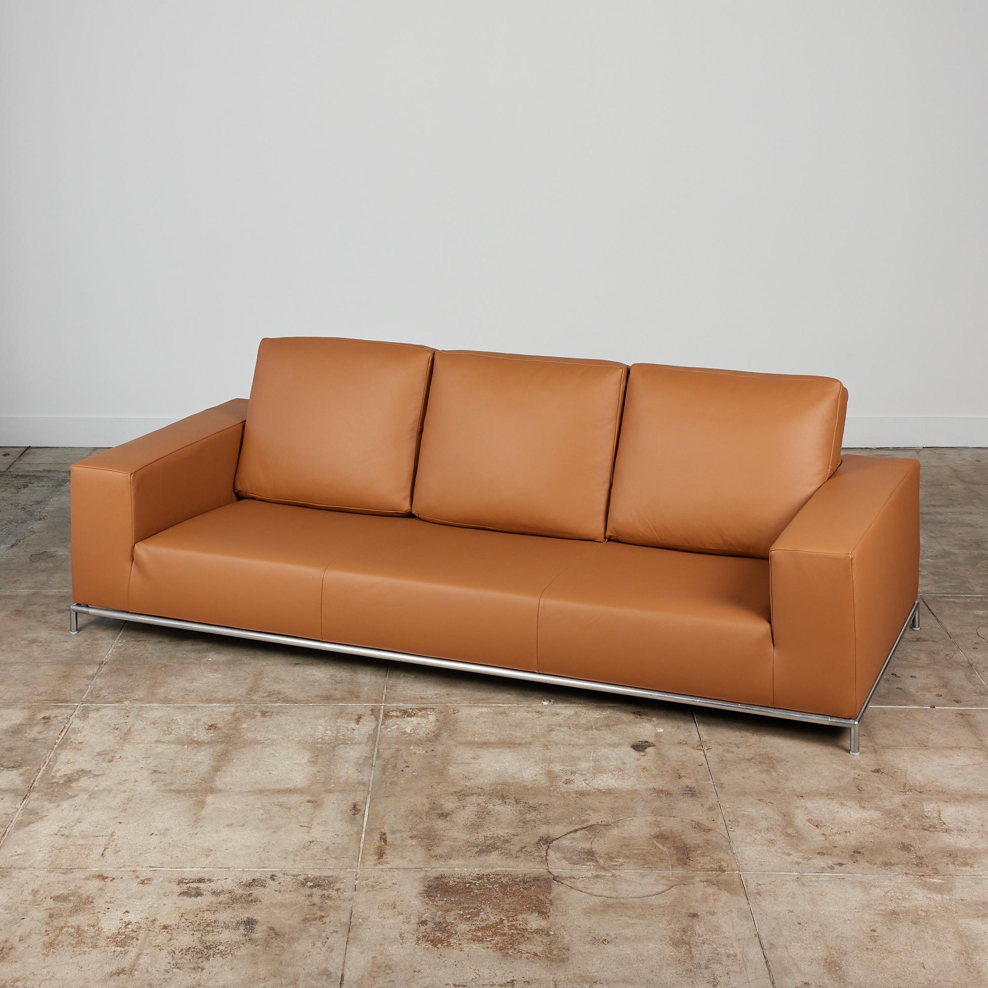 George sofa by Antonio Citterio for B&B Italia, c.2006, Italy. The three seater sofa features a slim tubular steel frame and has been newly reupholstered in a supple camel colored Edelman leather. The sofa has a deep seat and three over sized