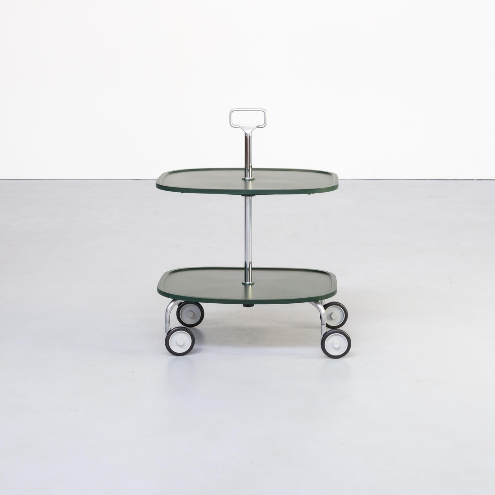 Elegant and practical serving trolley with varnished plastic top surface and chromed steel support.