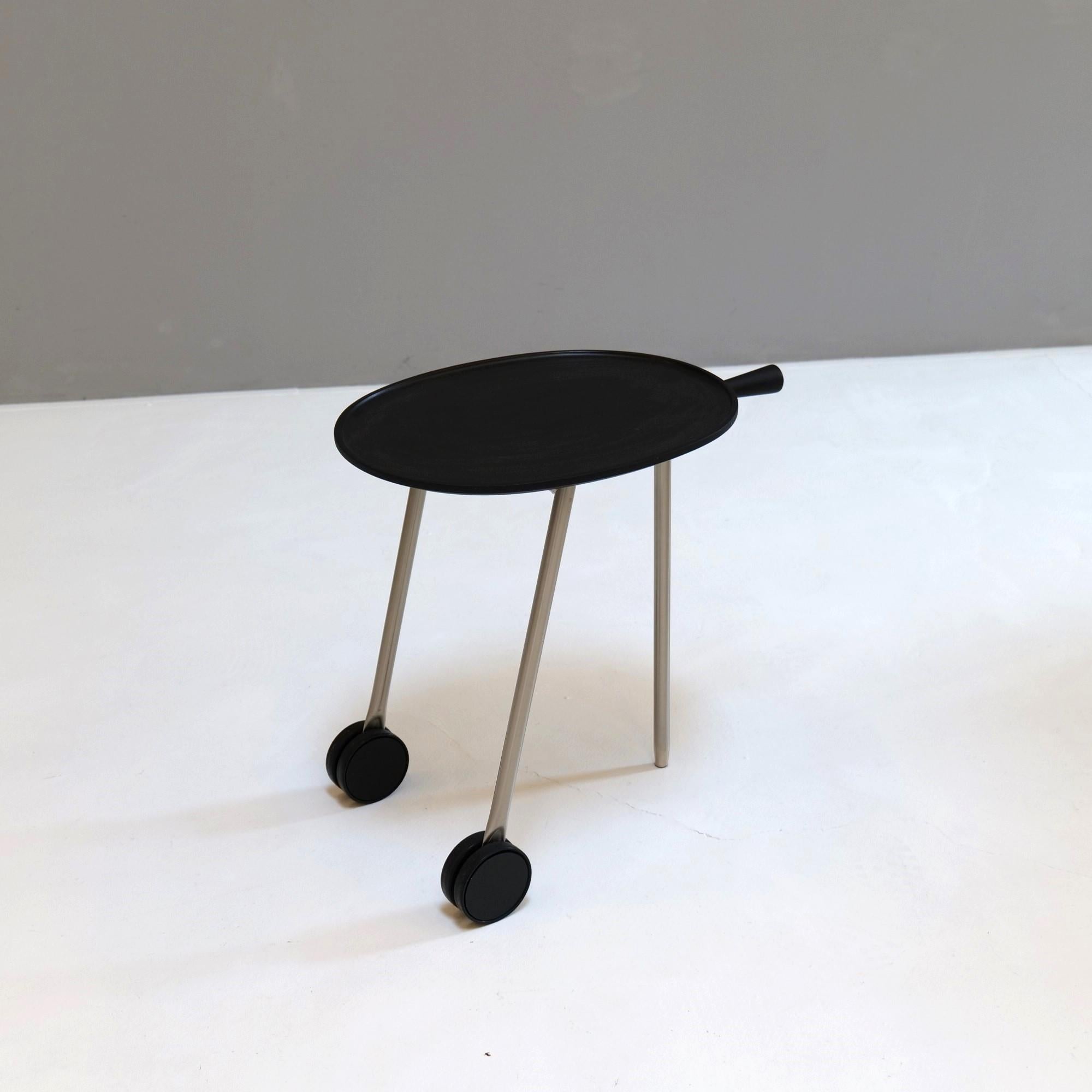 Antonio Citterio designed a small side table on castors with a black oval plastic top.

A handle and the two wheels allow the table to be moved flexibly.
