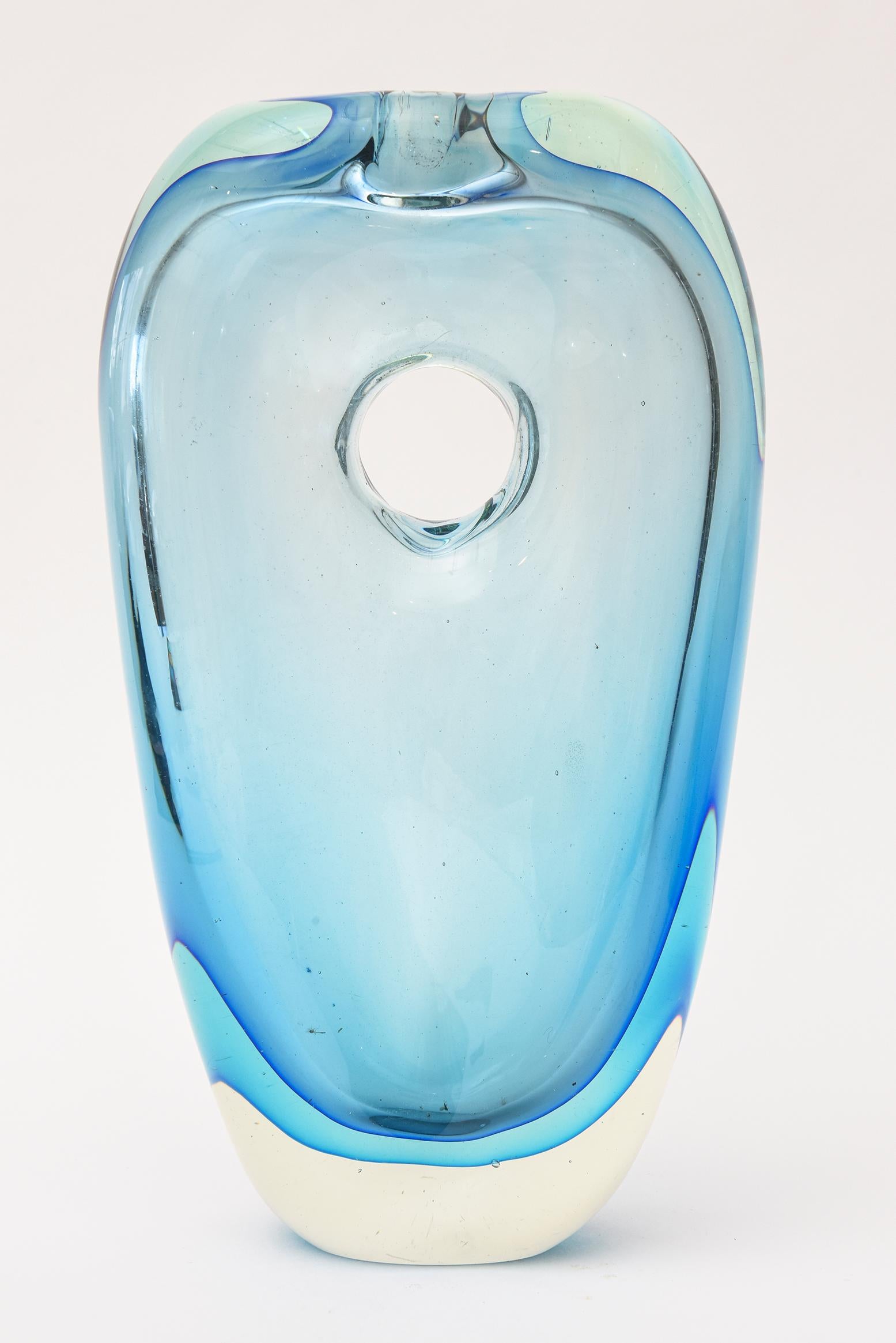 This gorgeous Italian Murano vintage Antonio da Ros for Cenedese Sommerso glass vase and or glass sculpture object has the luscious colors of blue meets turquoise meets robin’s egg blue. If you use it as a vase only a few flowers can fit as it does