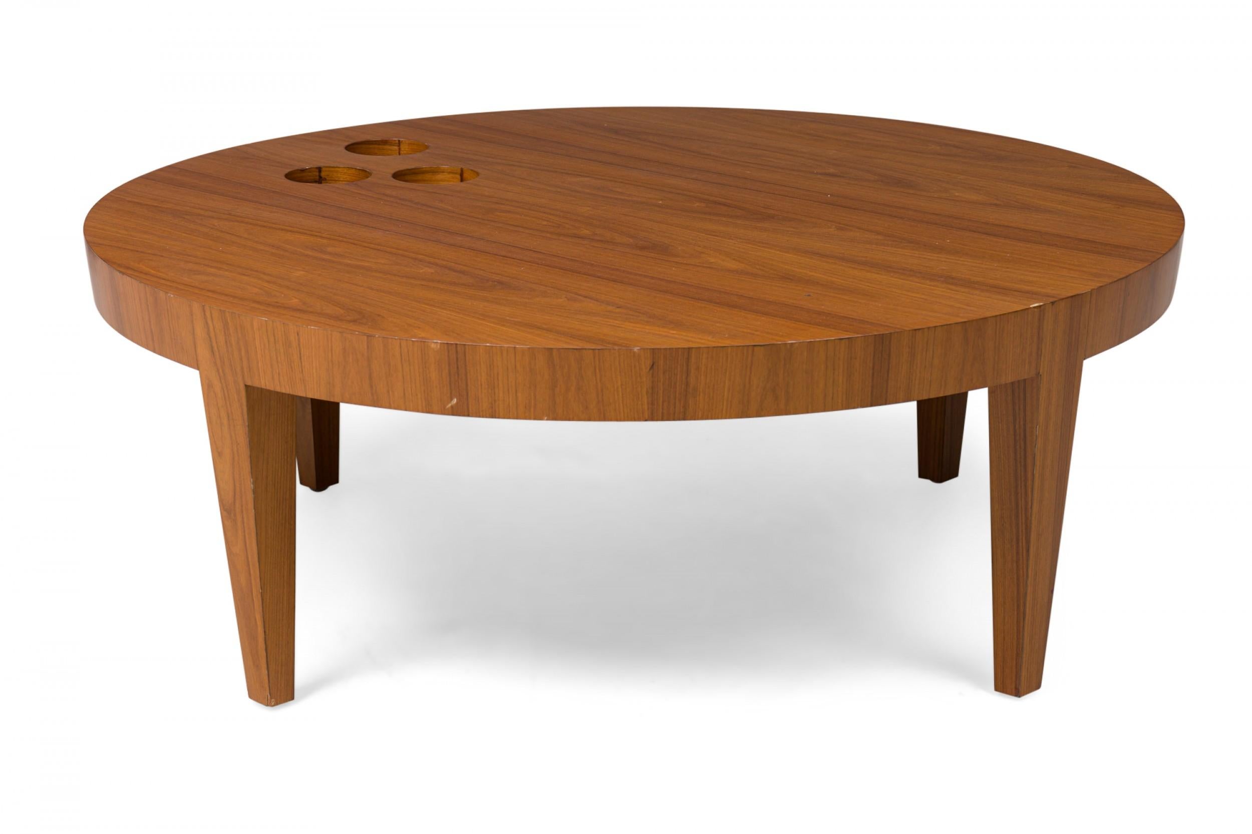 Contemporary American walnut circular coffee table with 3 round cutouts, resting on 4 tapered block legs (ANTONIO FORTUNA).